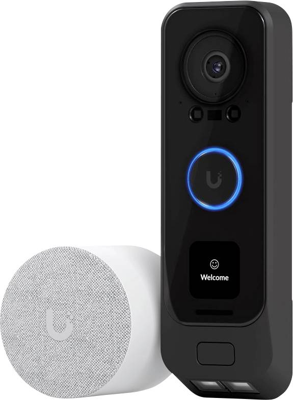 A smart doorbell with a camera and speaker. The doorbell has a display showing the text 'Welcome'. To the left is a white, cylindrical smart speaker.