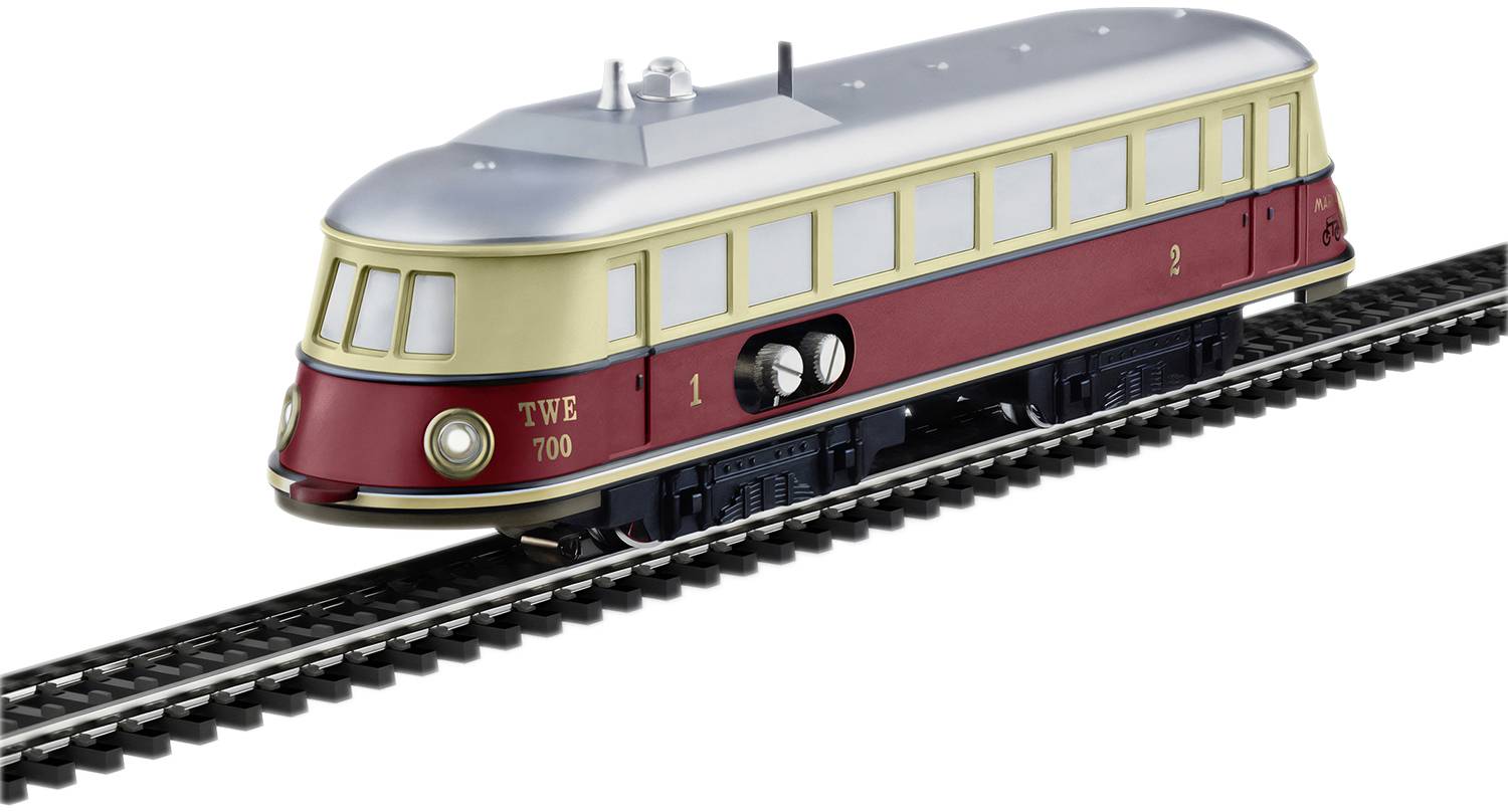 Colourful model train with rounded roof on tracks, red and cream paintwork, silver details. Toy for railway enthusiasts.