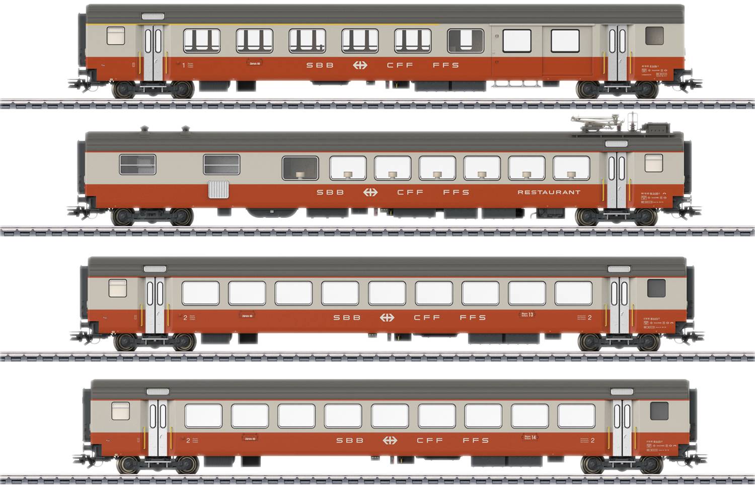 Four different historic railway carriages in red and grey colours on tracks, including a restaurant car.