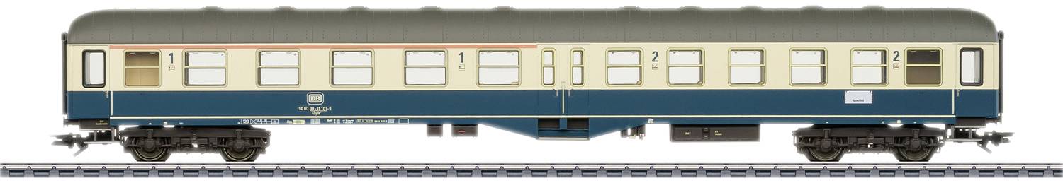 A model railway passenger carriage in H0 scale in blue and beige with detailed windows and markings, standing on a track.
