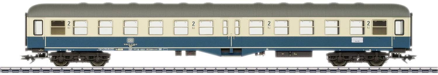 A second-class model train passenger carriage, painted blue and beige, with the inscription 'Deutsche Bundesbahn'. The carriage is standing on railway tracks.