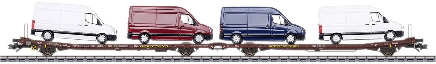 Four delivery vans in white, red, blue, and white are loaded onto a railway wagon. They are parked side by side in a row.