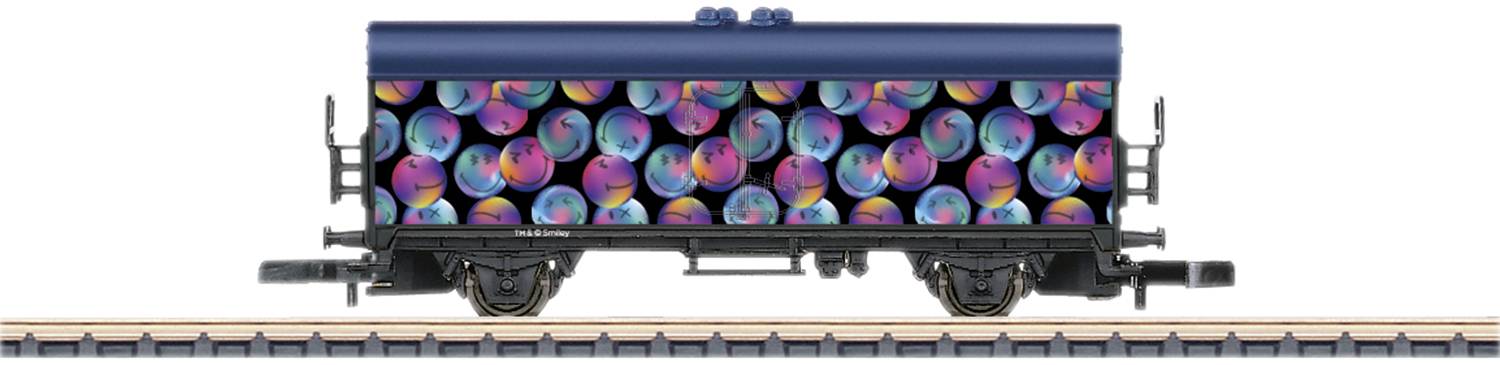 A goods wagon on rails is adorned with a vibrant, colourful pattern of spiral shapes in blue, purple, and yellow.
