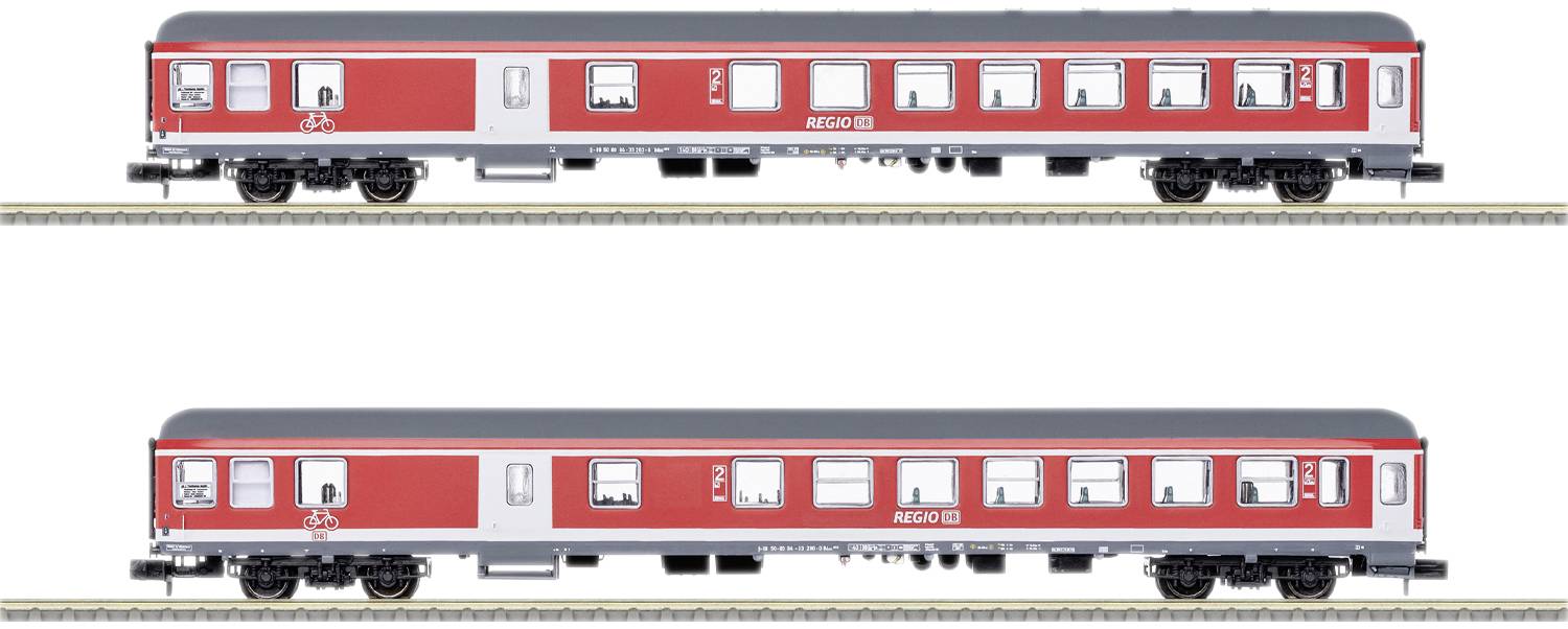 Two red regional trains on the track. The upper train displays a bicycle symbol, the lower one is identical without the symbol. Both have multiple windows.