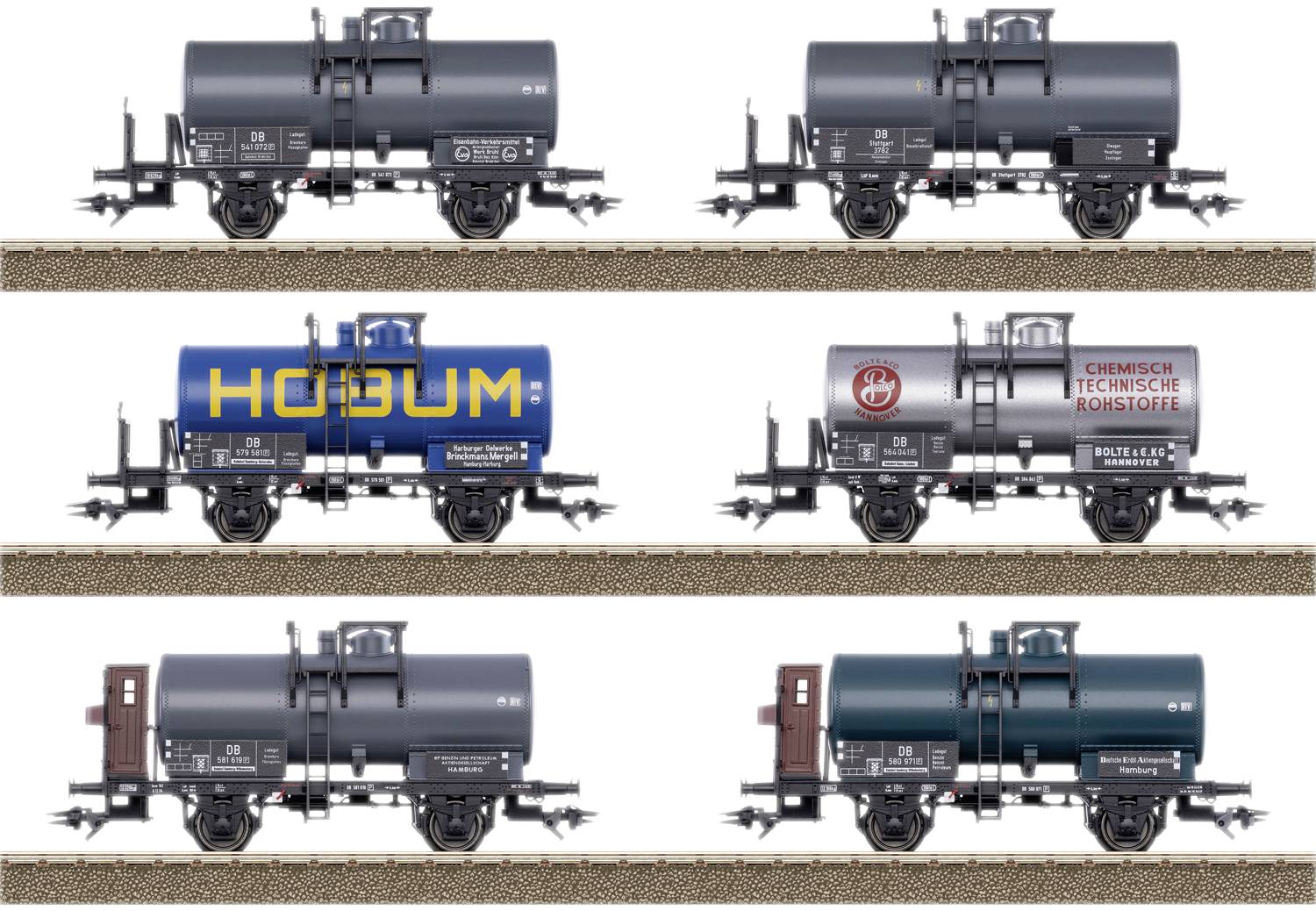 Six model railway tanker wagons on tracks, each with different designs and prints.