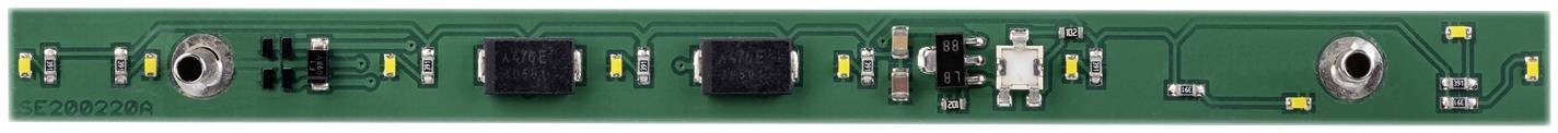 A green printed circuit board with several electronic components, such as resistors and capacitors, arranged in a row.