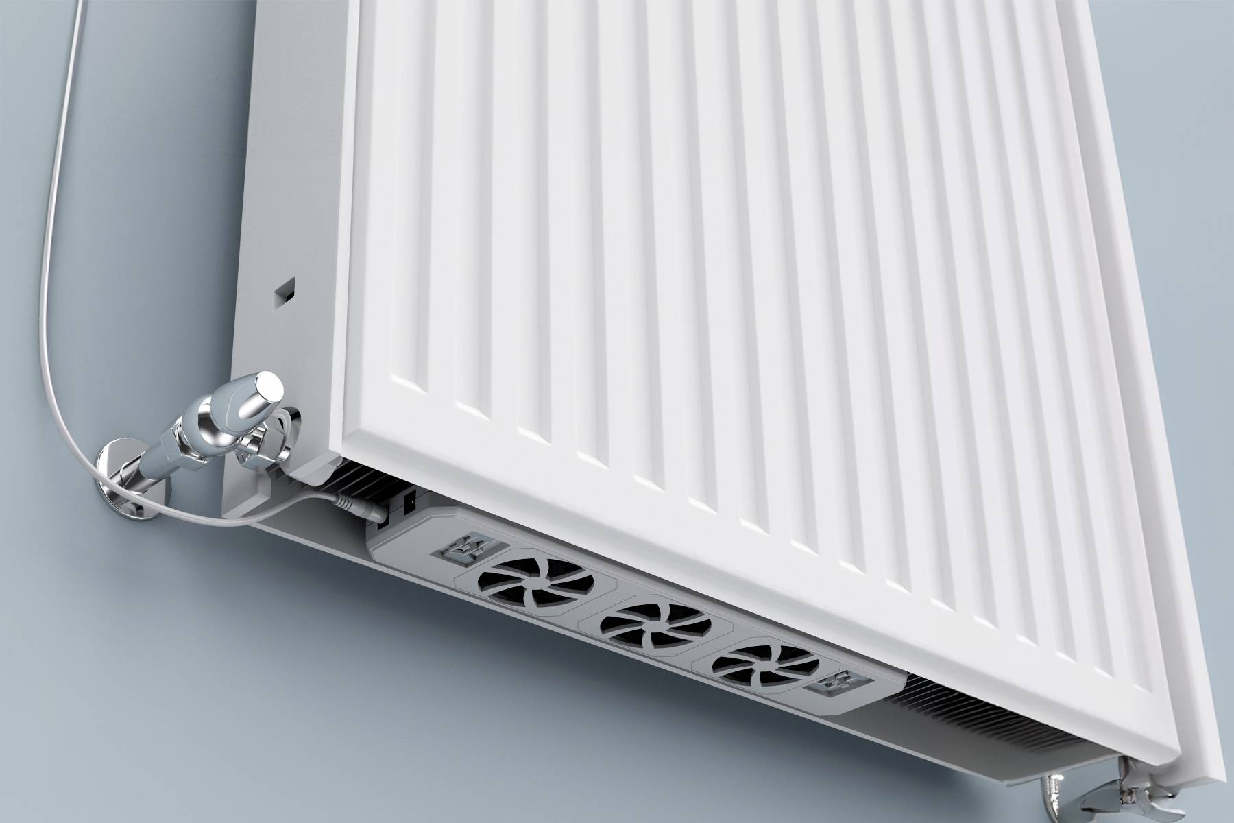 A white radiator on a blue wall, with visible pipe connections at the bottom left. It shows a modern heating design.