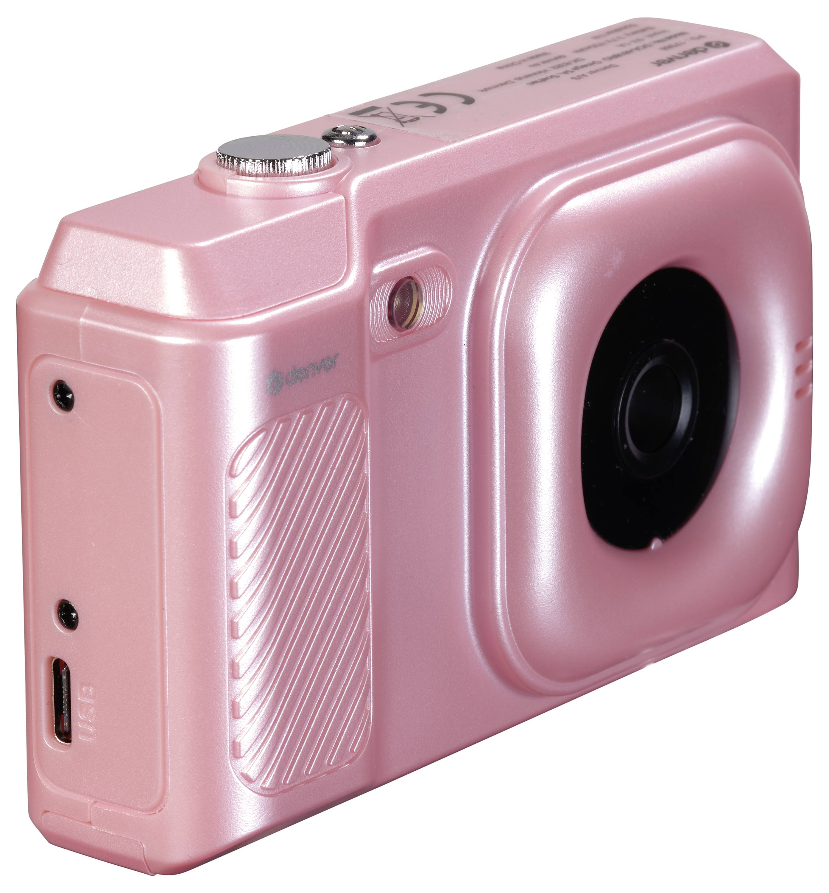 Pink digital camera with a smooth surface and large lens, side view.