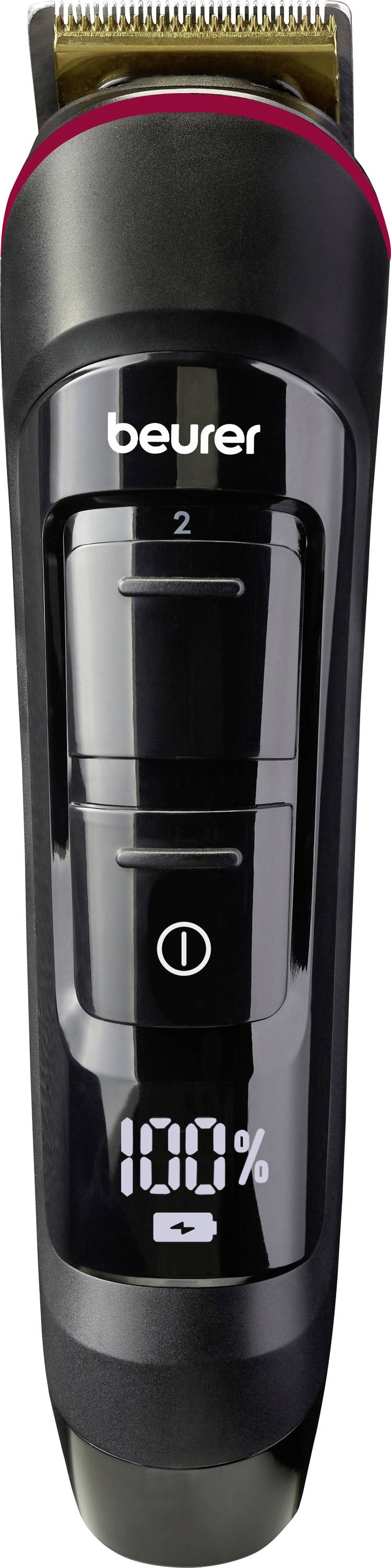 Electric hair clipper in black with LED display showing '100%'; brand 'beurer'. Attachment comb on top, power button in the centre.