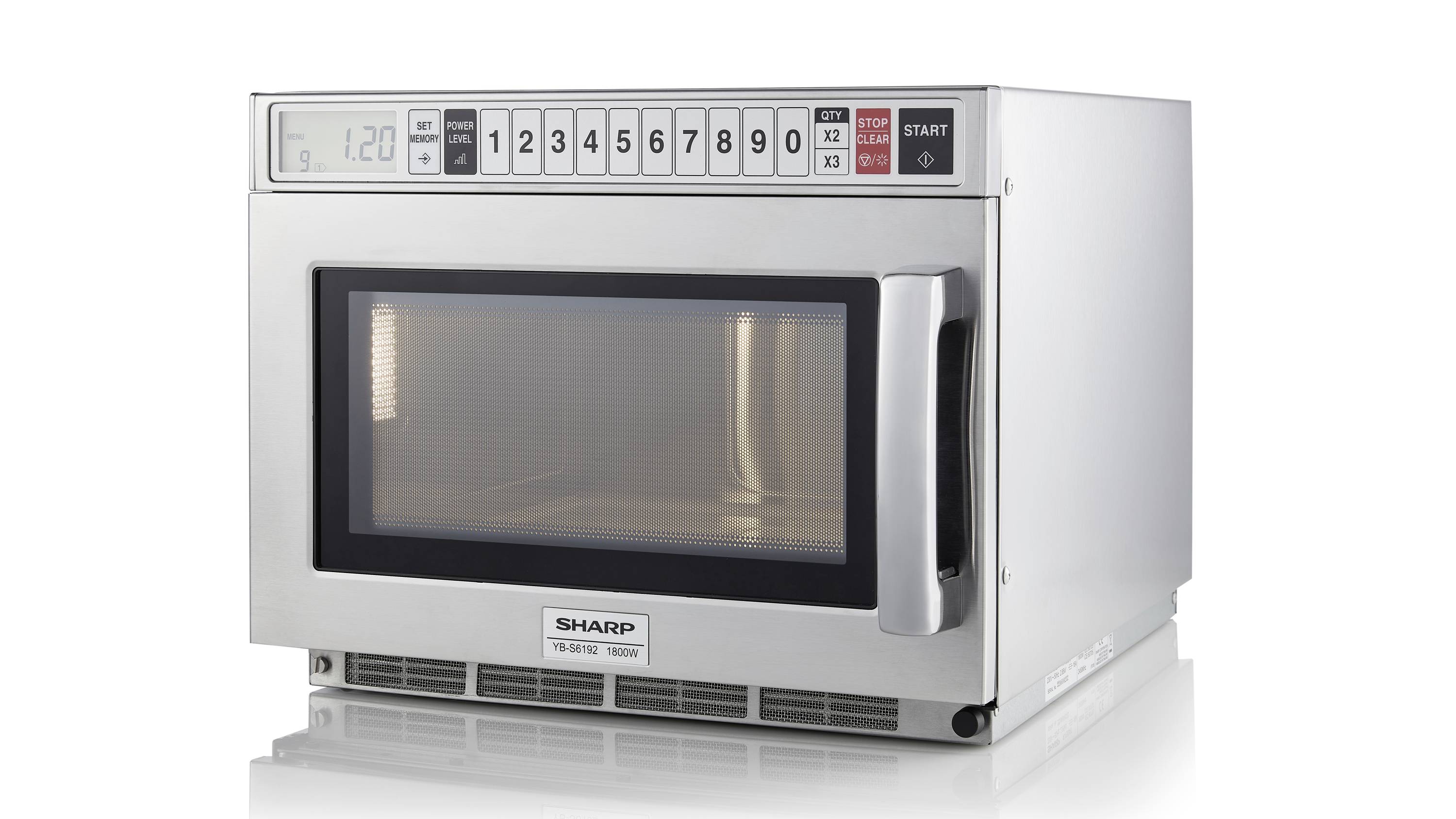 A silver microwave with numerical buttons and a digital display shows '1:20'. The door has a large window.