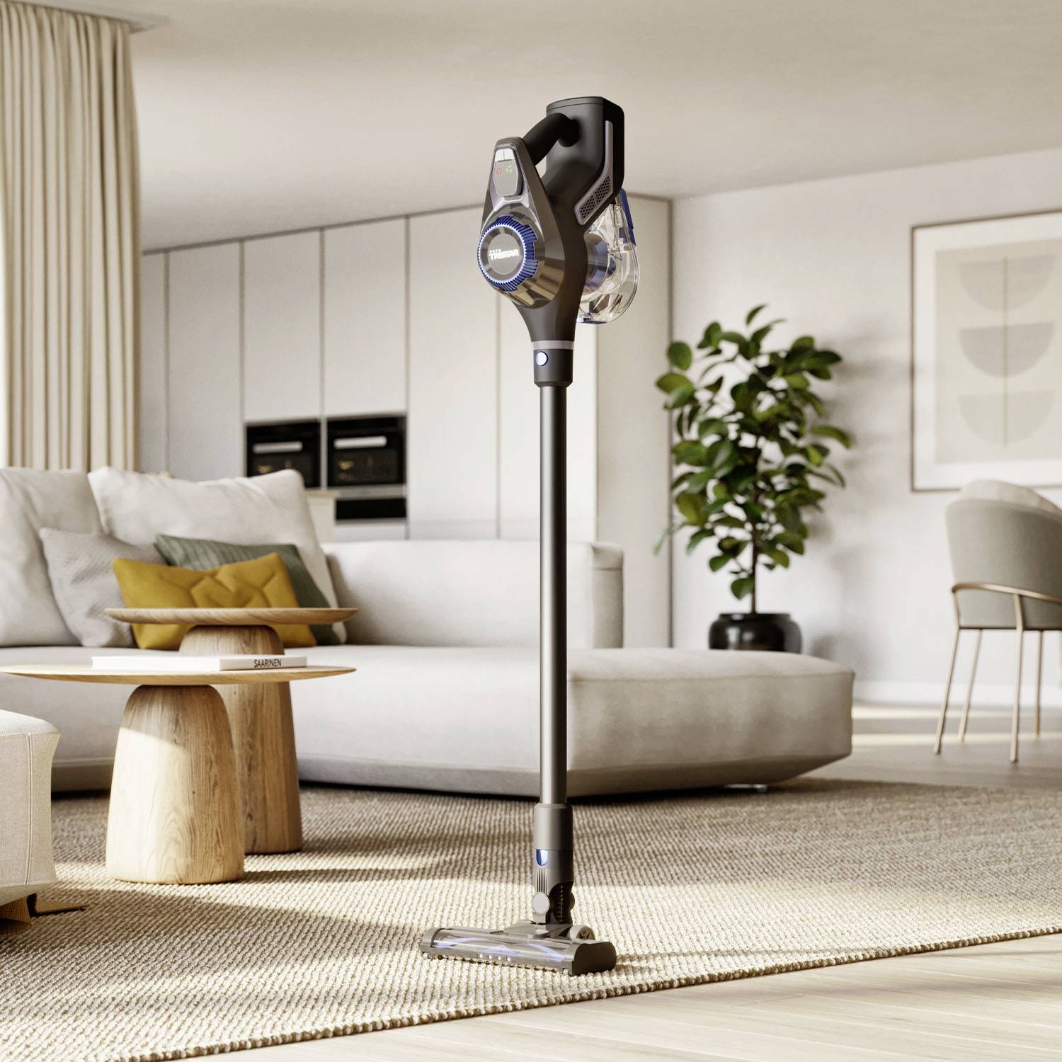 A modern cordless vacuum cleaner stands in a stylishly decorated living room with sofas, a table, and plants in the background.