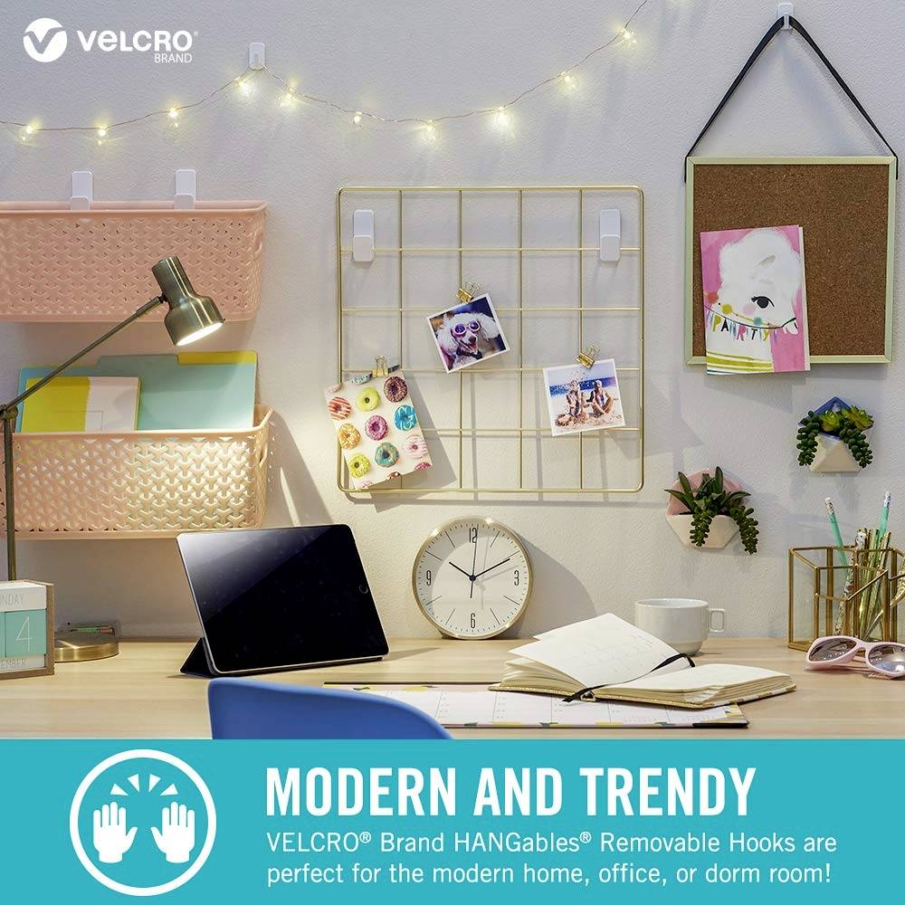 Workspace with desk lamp, laptop and organiser. Decorative lights and pictures on the wall. Text: 'MODERN AND TRENDY'.