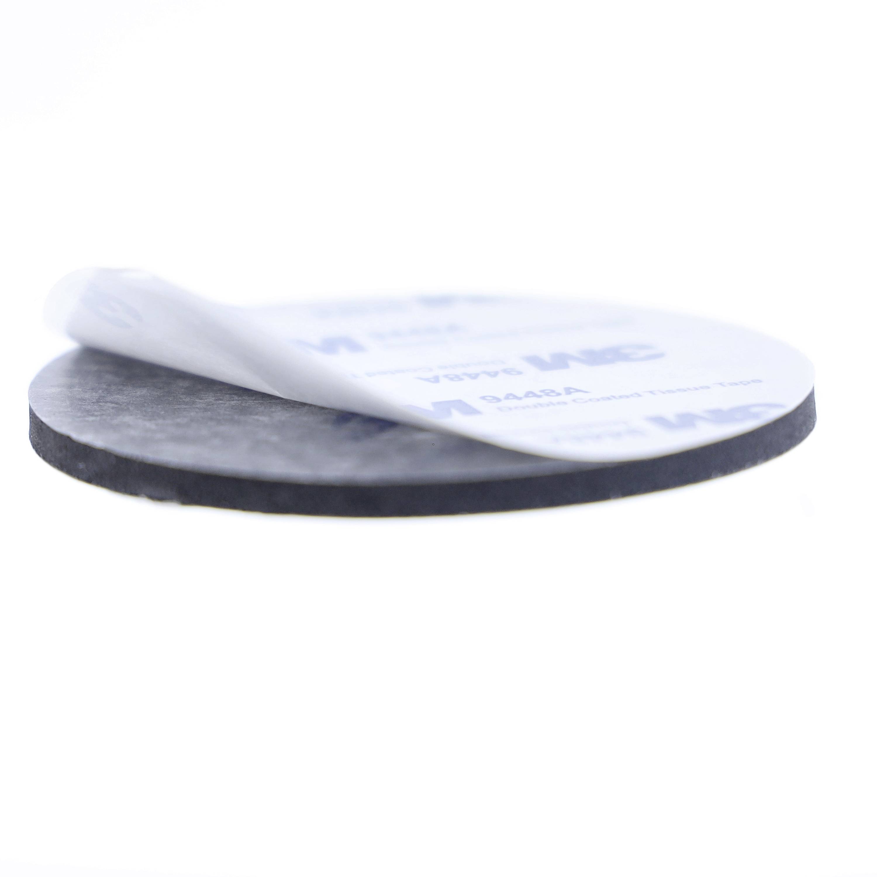 A round, black mat with a removable protective film that is partially peeled off. Ideal for non-slip applications.
