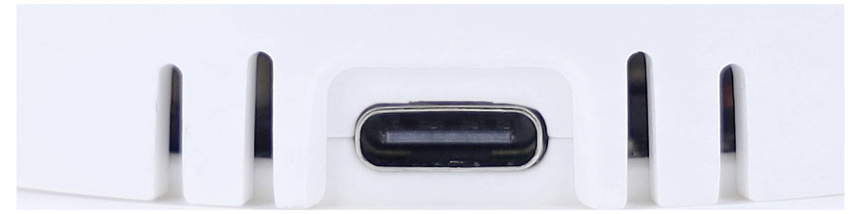 Close-up of a USB-C port on a white device, possibly part of an electronic product such as a charger or hub.