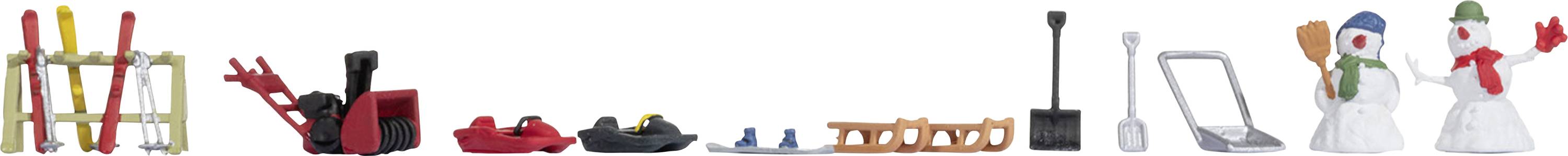Toy representation of a winter landscape with skis, a snowmobile, ski boots, a sledge, a laptop, and snowmen.