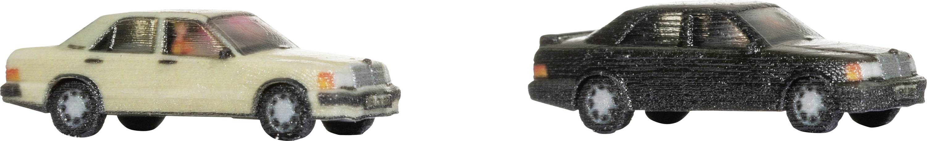 Two toy cars, one beige and one black, side by side on a white background. Both are classic saloon car models.