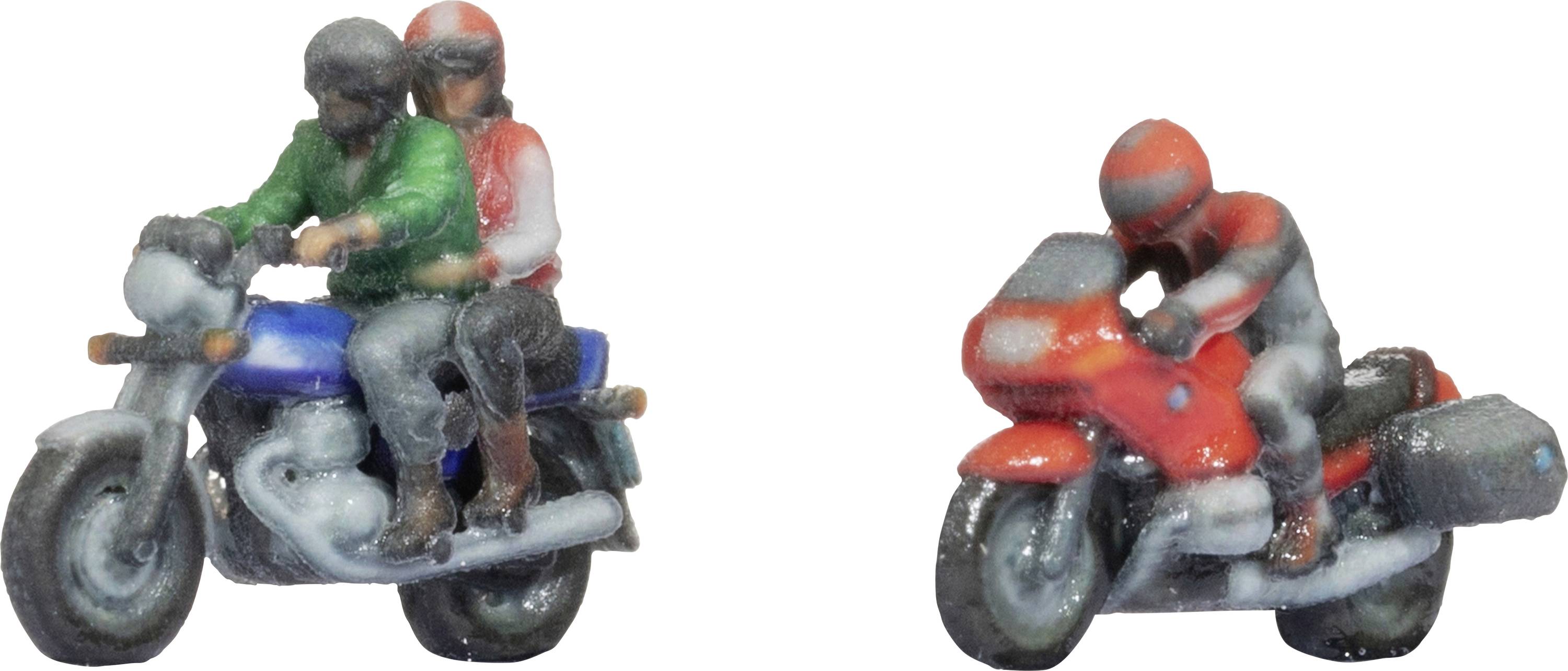 Two miniature figures on motorcycles, one with a pillion passenger wearing a green jacket on a blue bike, the other in red on a sporty motorbike.