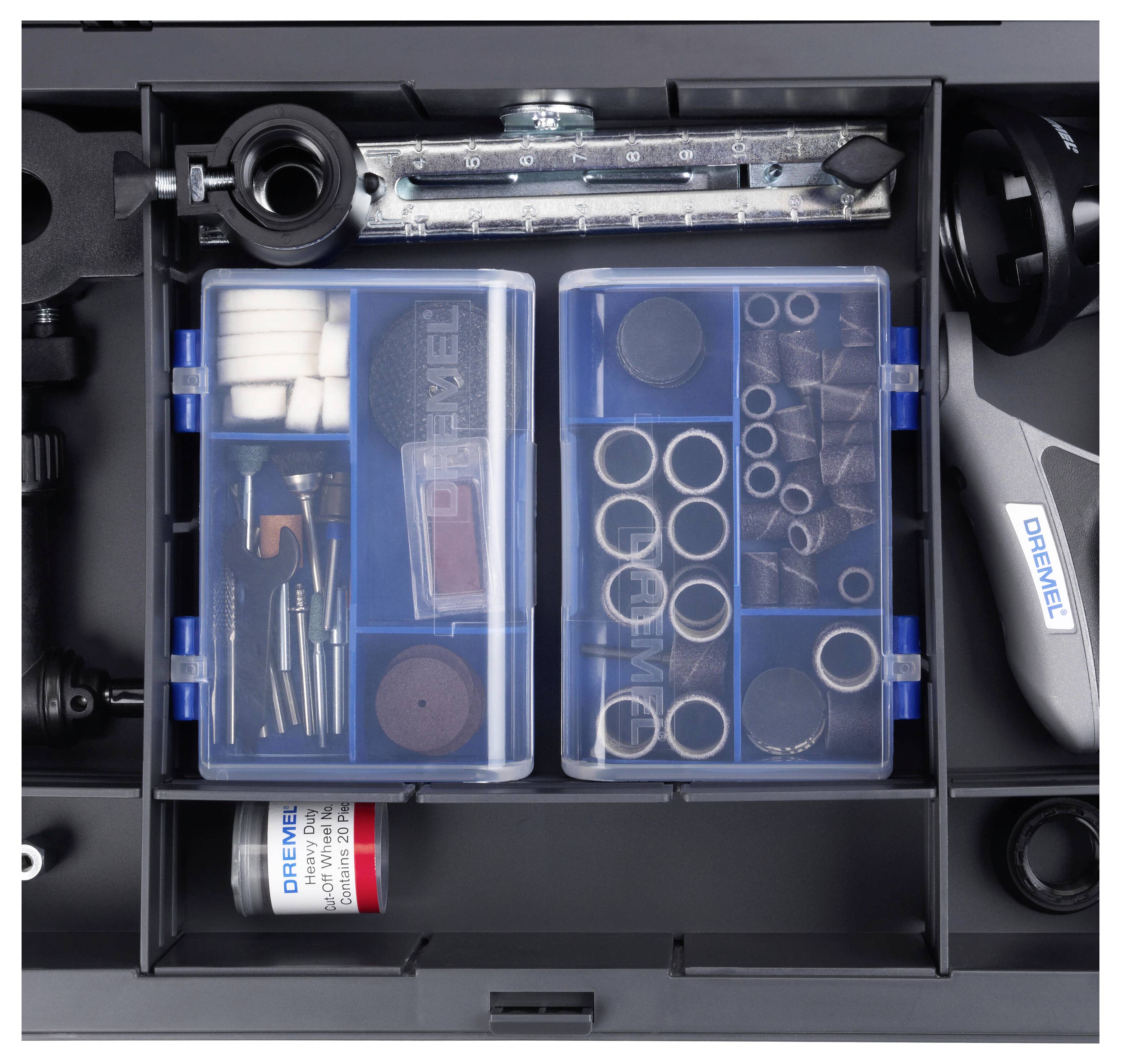 Open toolbox with various Dremel accessories, including polishing and grinding discs, milling cutters and attachments in compartments.