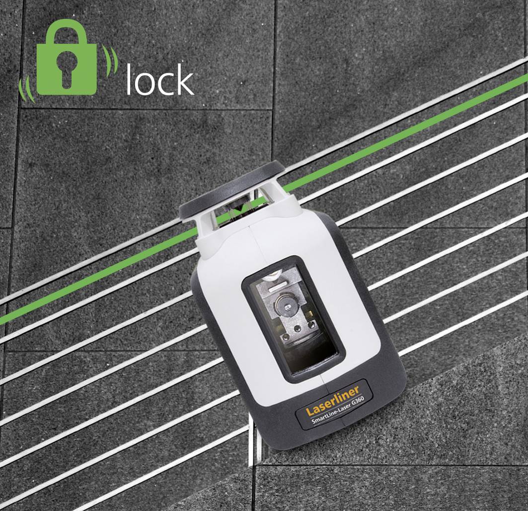 A laser levelling device projects green lines onto a dark floor covering. A 