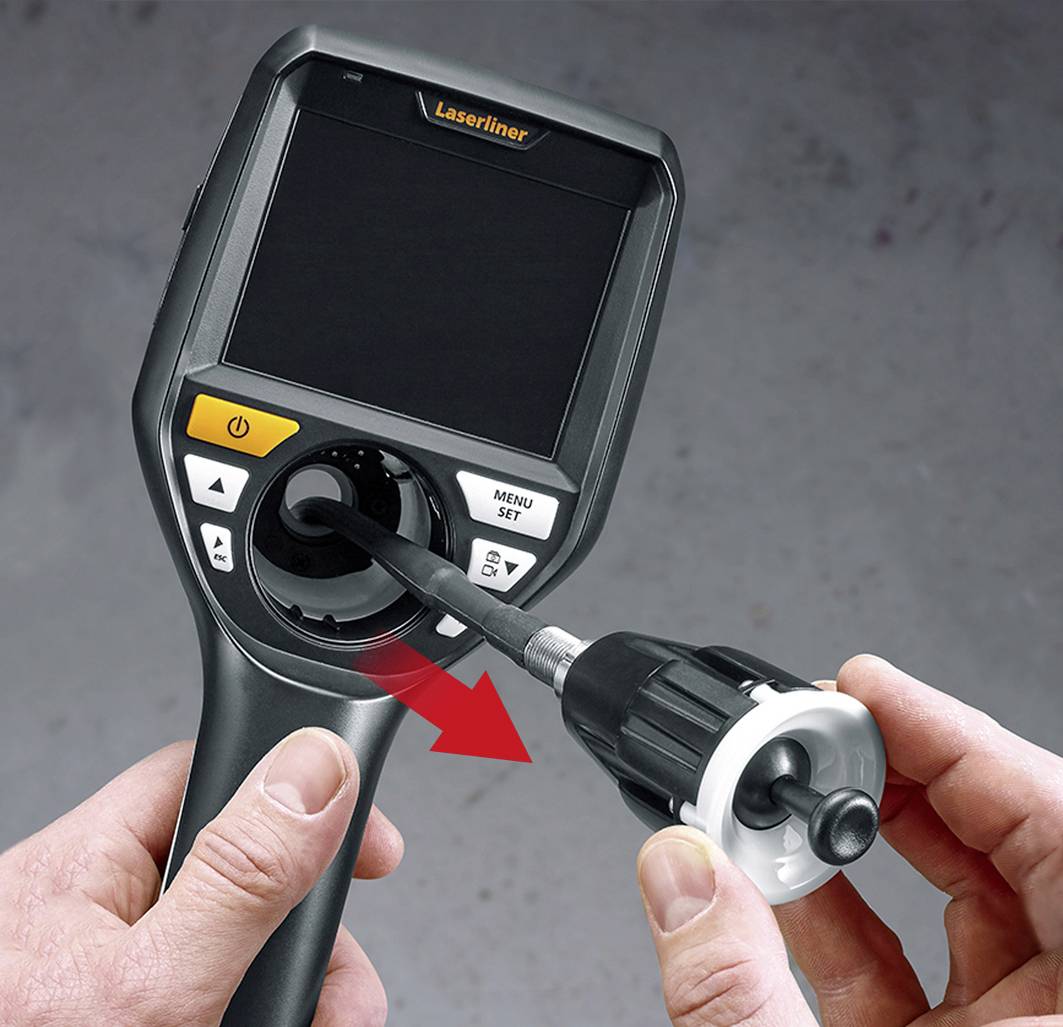 A person is holding an inspection camera device and inserting a flexible probe into the lens to use the device.