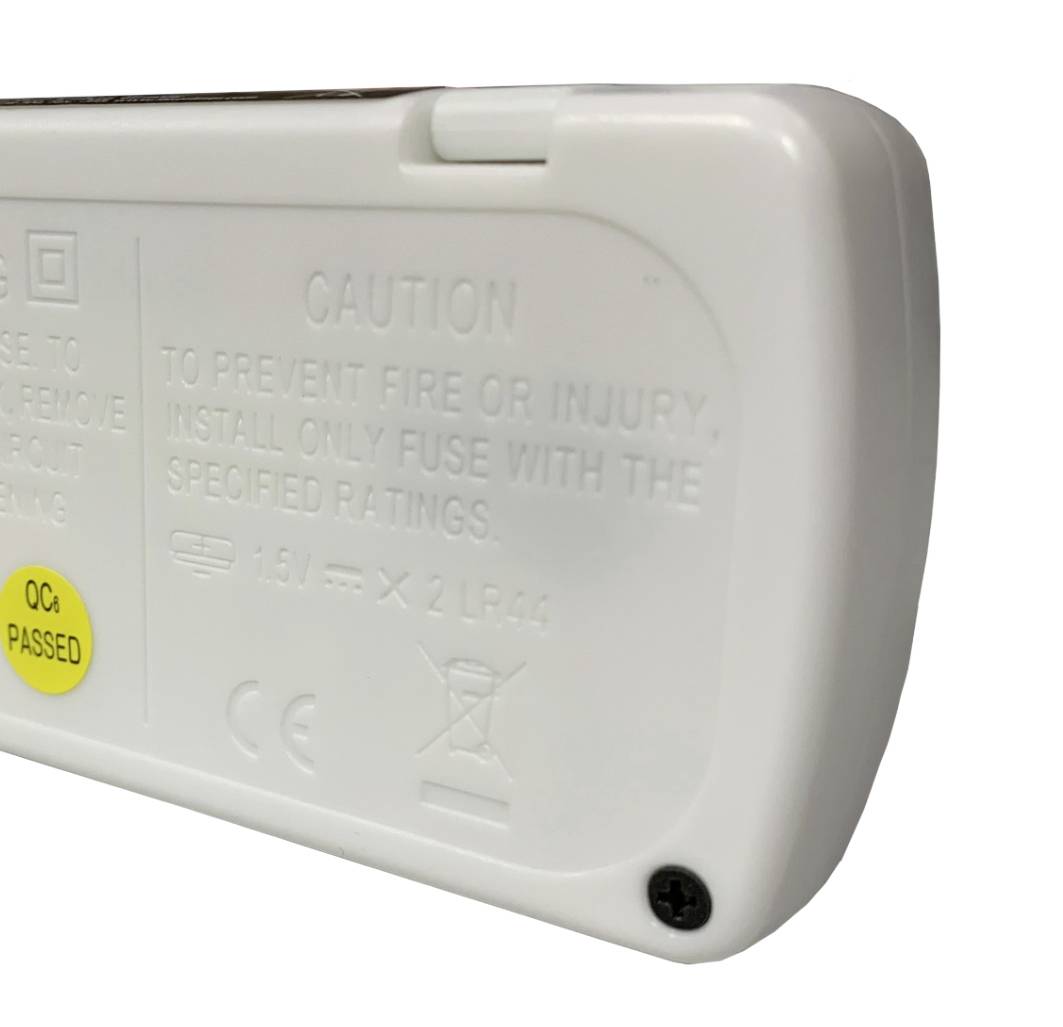 A white plastic casing with a sticker indicating 'QC PASSED'. Includes warnings for the safe use of batteries.