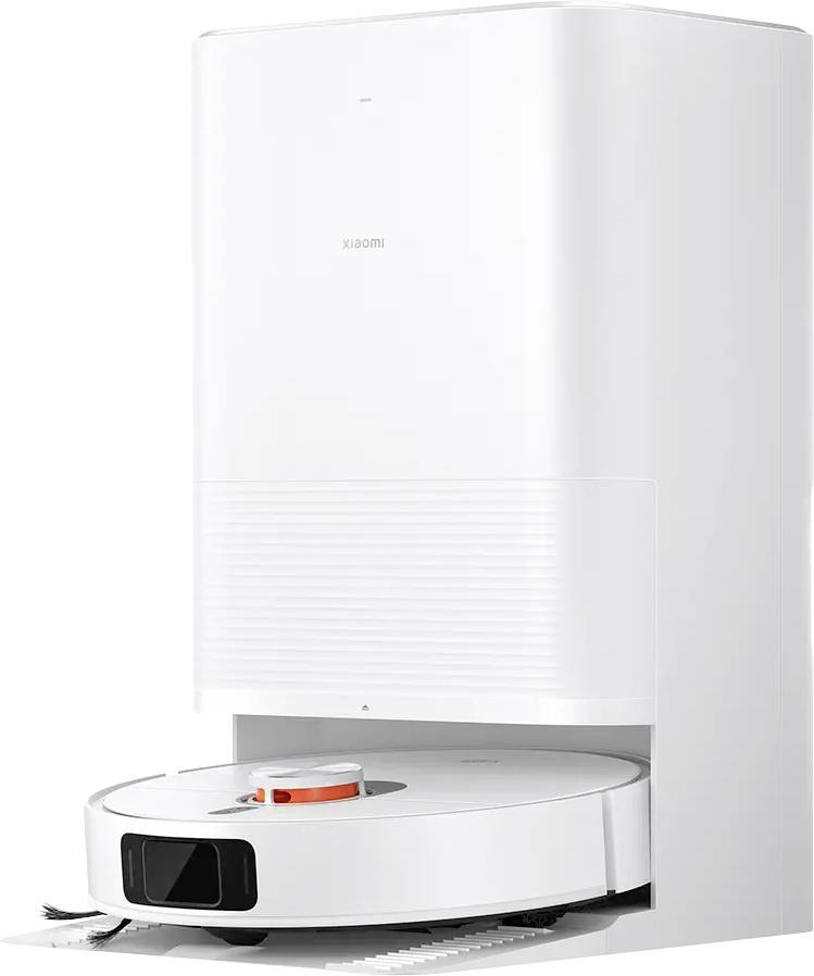 A white robotic vacuum cleaner docks at a charging station.