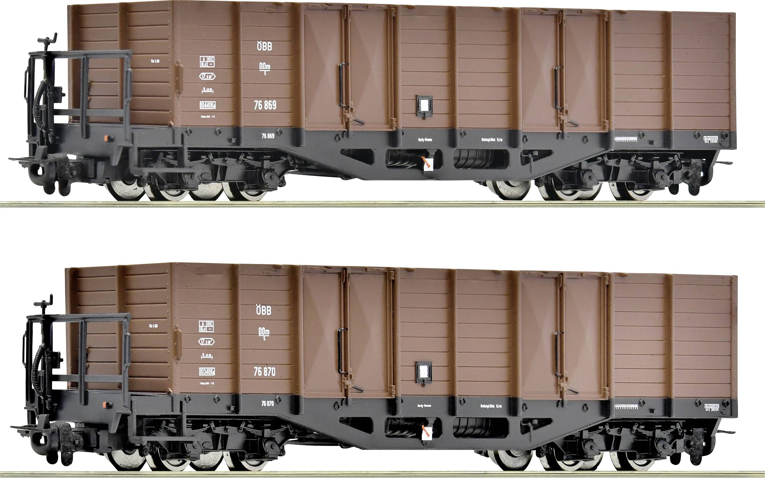 Two brown goods wagons on railway tracks, identical in design, with labelling on the side. Suitable for bulk cargo transport.