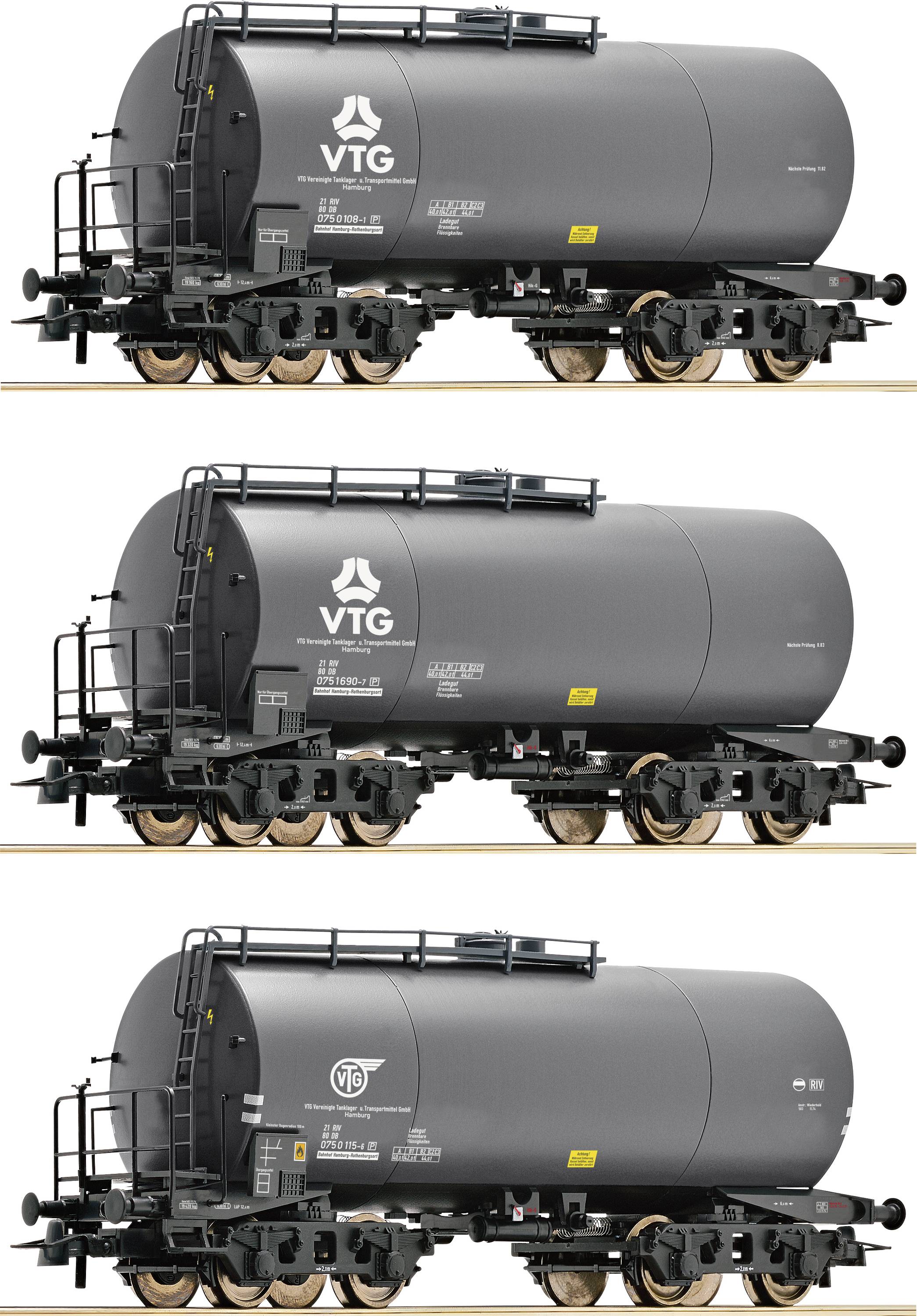 Three grey tanker wagons on railway tracks, each with different company logos. They are used for transporting liquids.