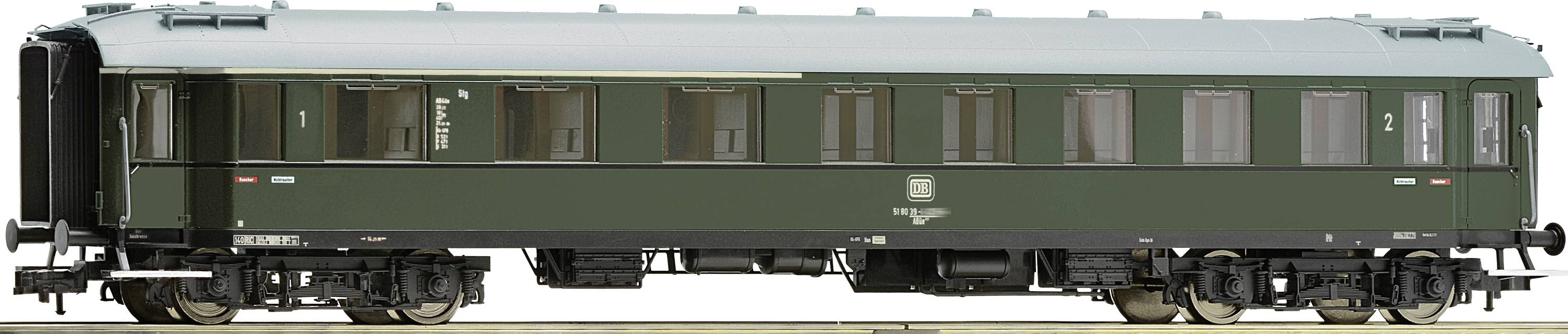 A green, historic passenger carriage from the Deutsche Reichsbahn with multiple windows and lettering on its side.