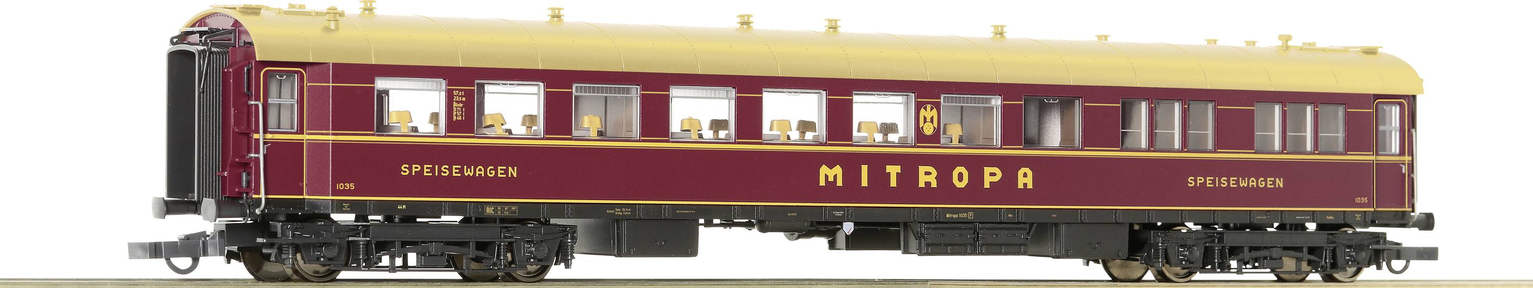 A red dining car from the 'Mitropa' brand on railway tracks, with a golden inscription. The train has multiple windows and a yellow roof.