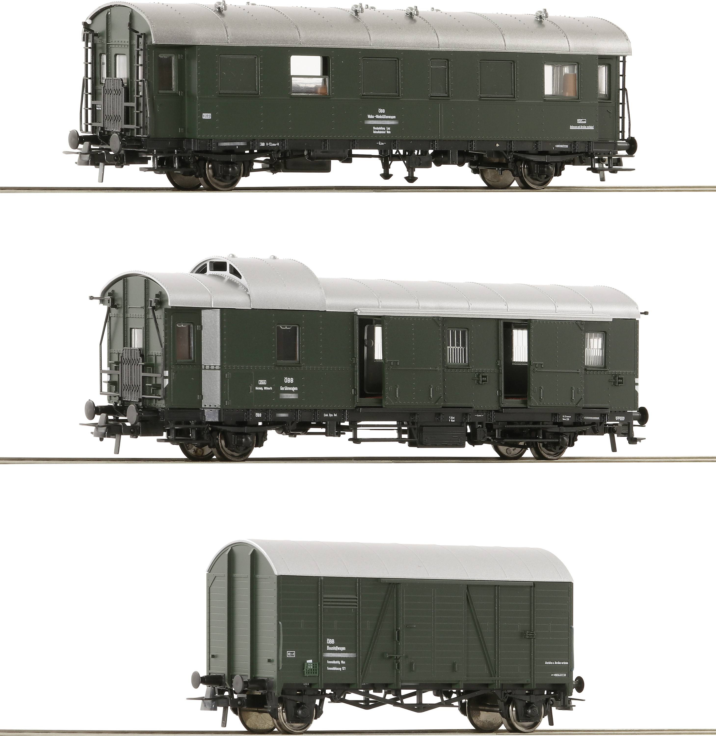 Three model railway carriages in different views: A green passenger carriage, a goods wagon with lattice windows, and a closed goods wagon.