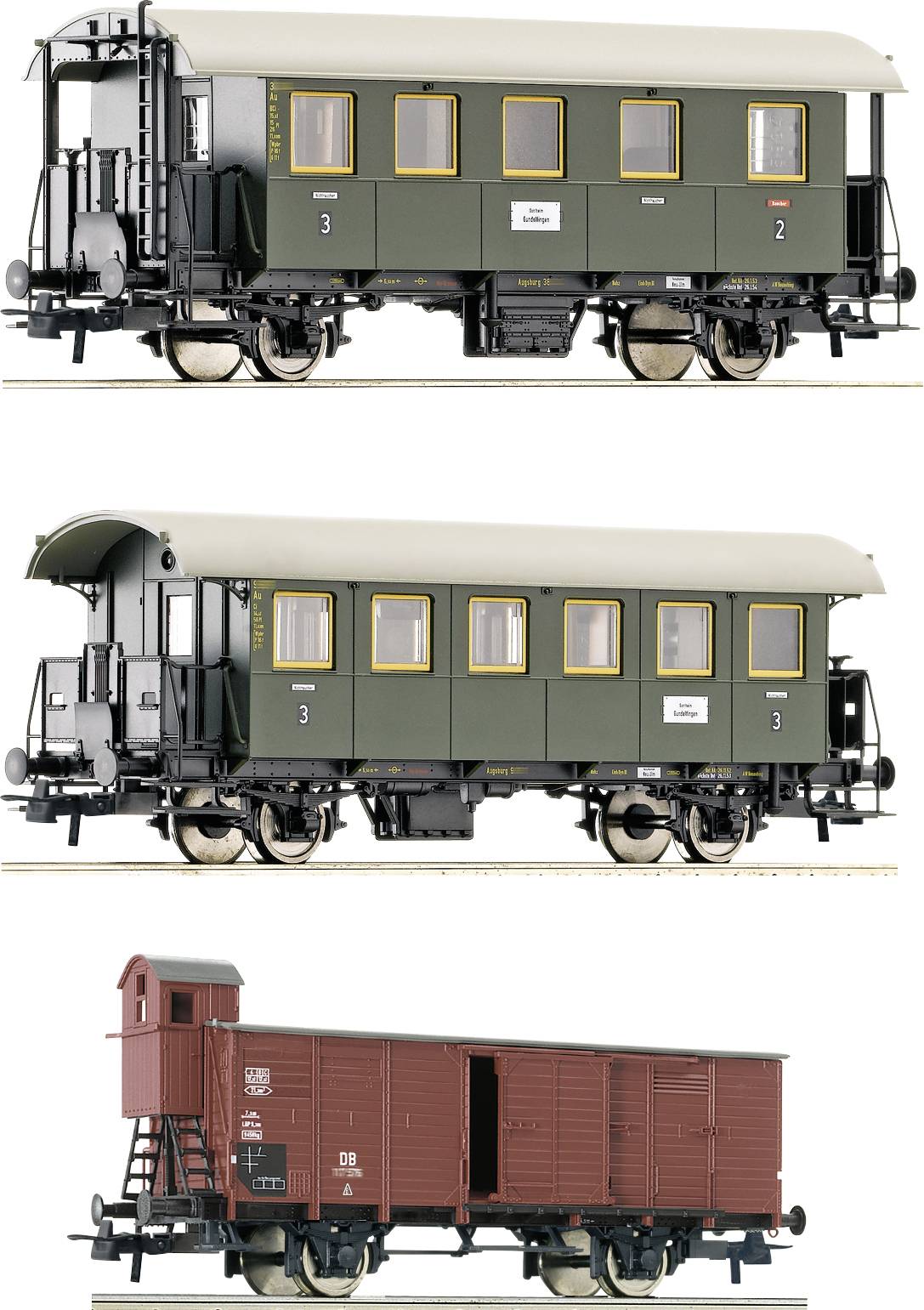 Three model railway carriages: two green passenger coaches with windows and yellow trim, one red goods wagon with a small superstructure.