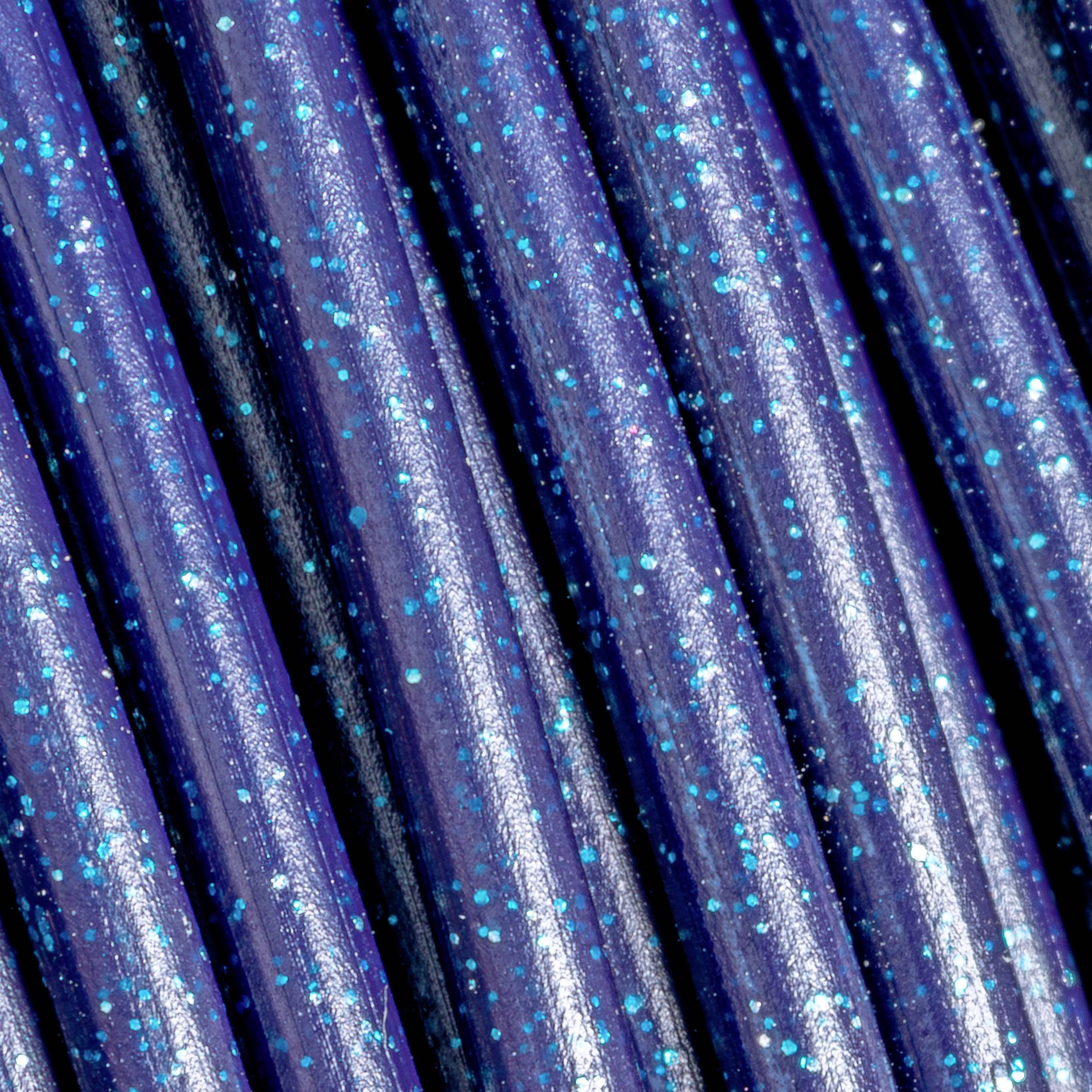 Close-up of shiny, blue cables with glittering spots. The cables are arranged closely together and reflect light.