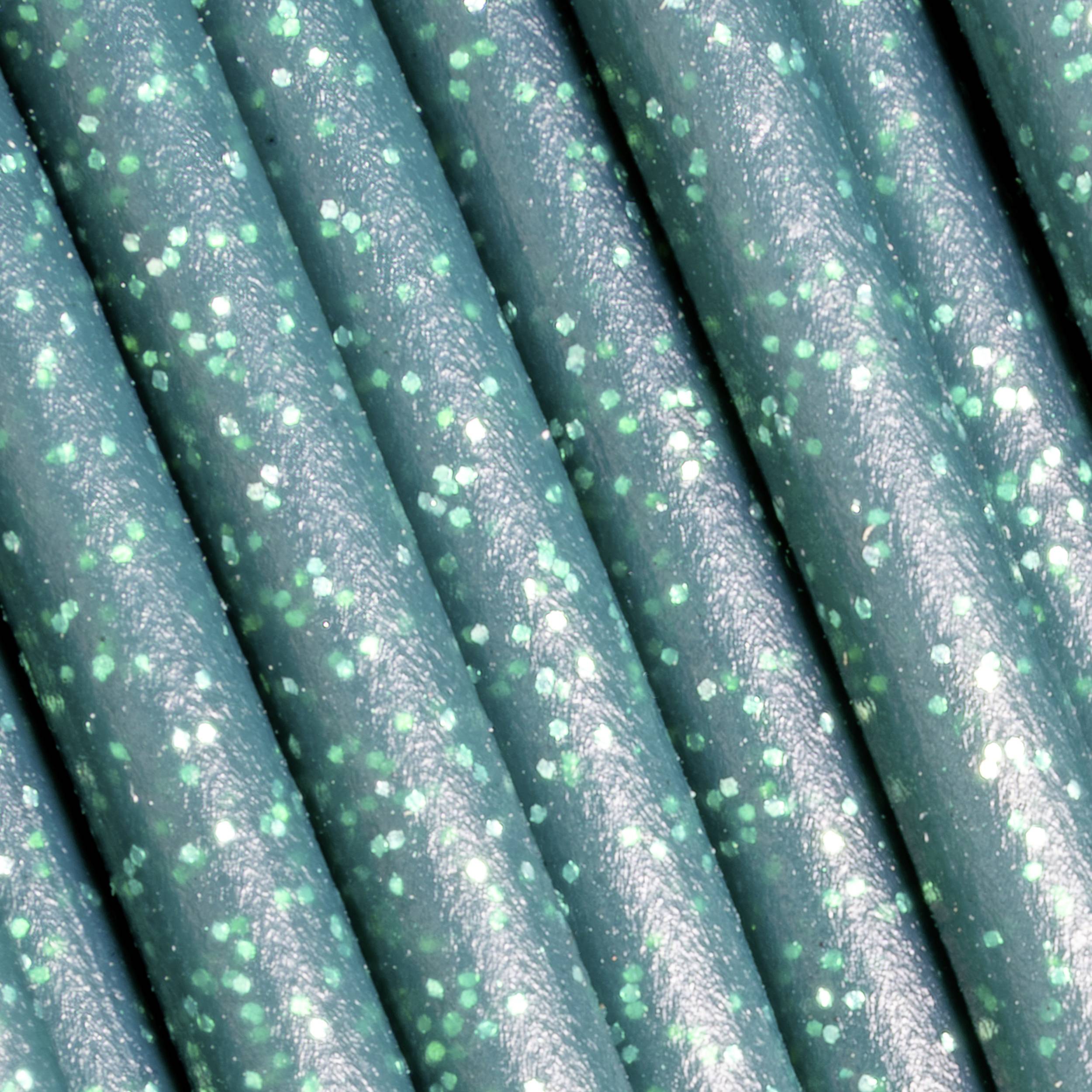 Turquoise-green glittery surface, close-up. Shimmering lines give the texture a vibrant, sparkling effect.