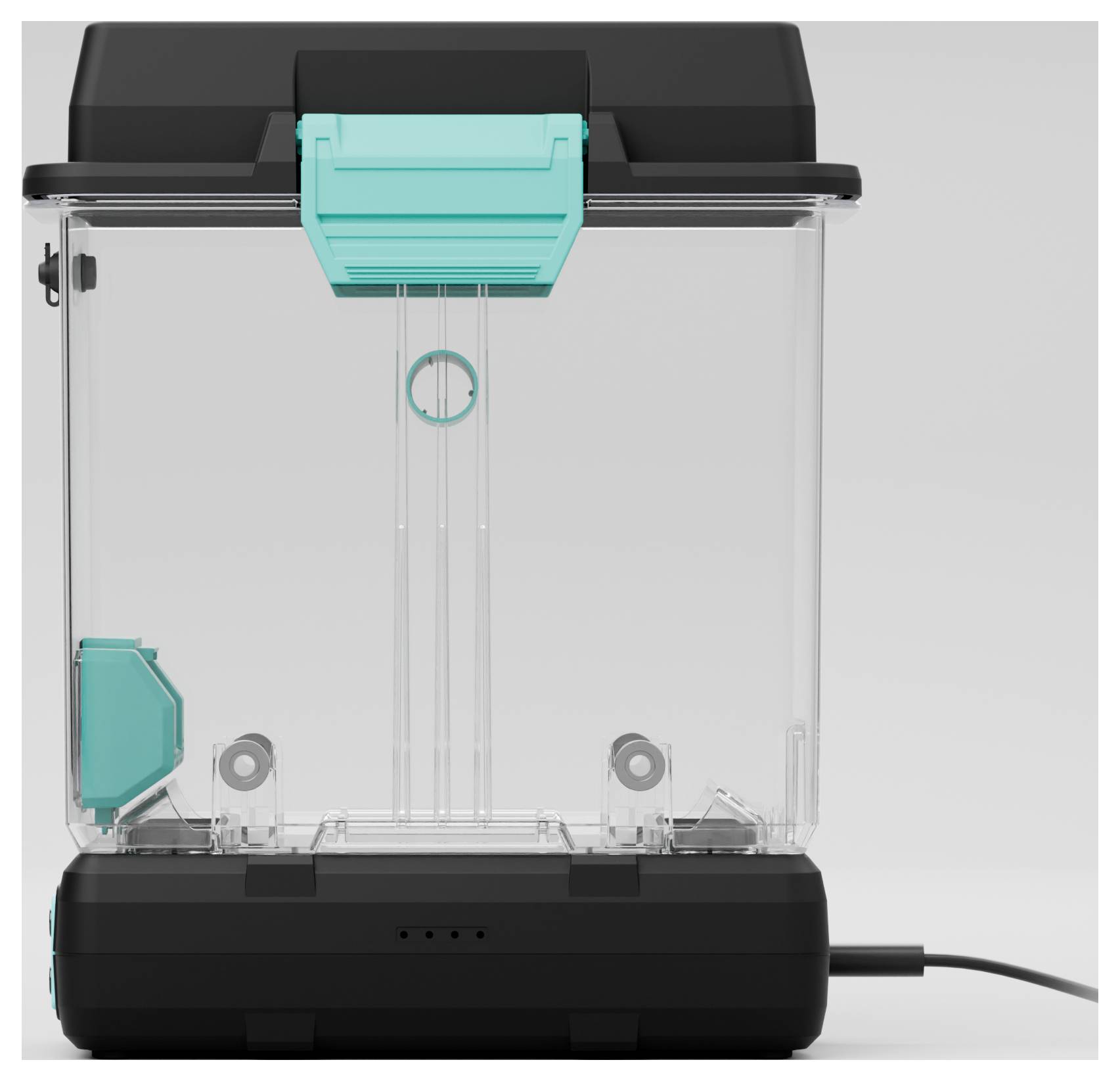 A transparent, rectangular container with a black lid and turquoise elements stands on a black base with cable connection.