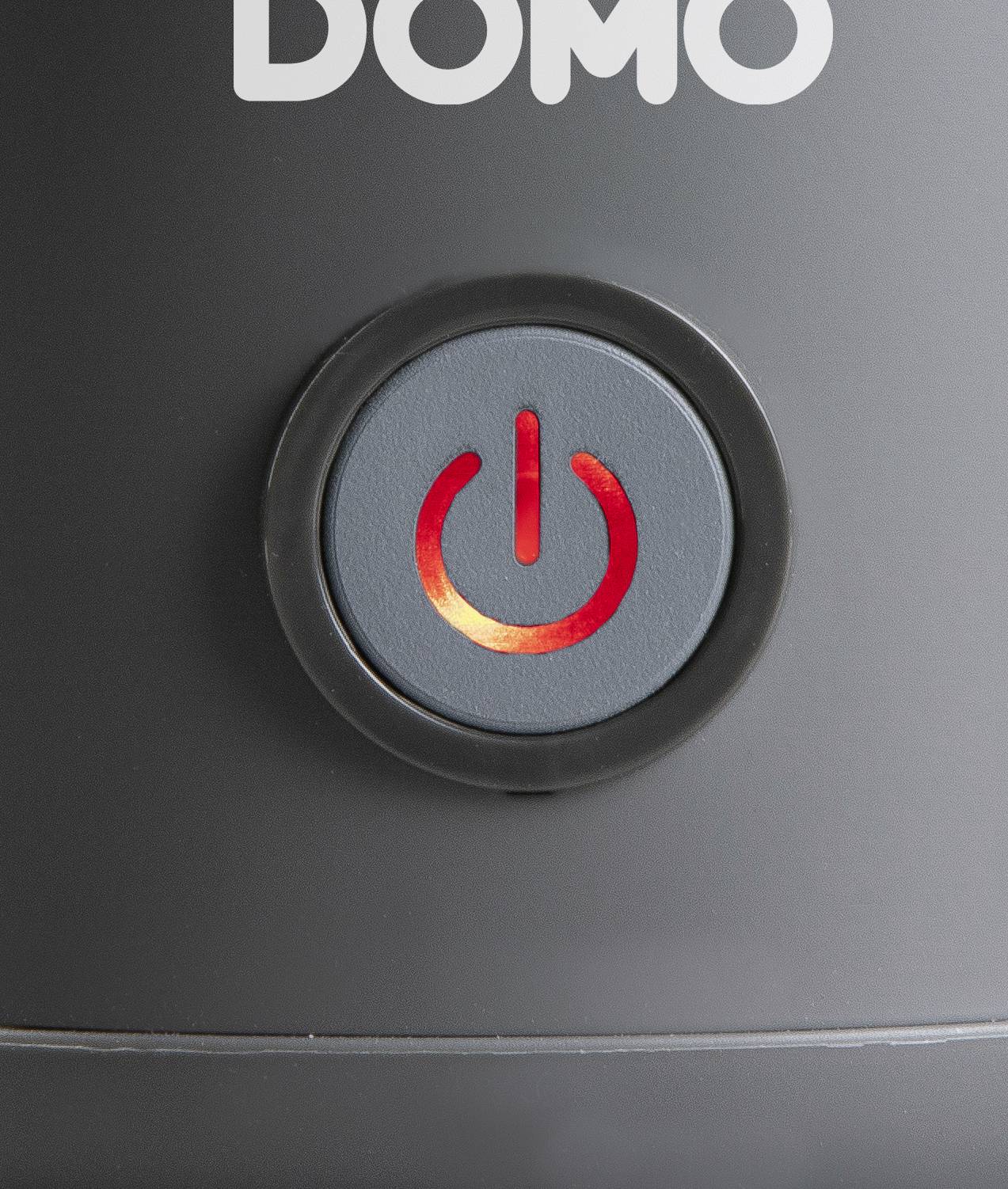 A bright red power switch on a black electrical device, with the word 'DOMO' located above the button.