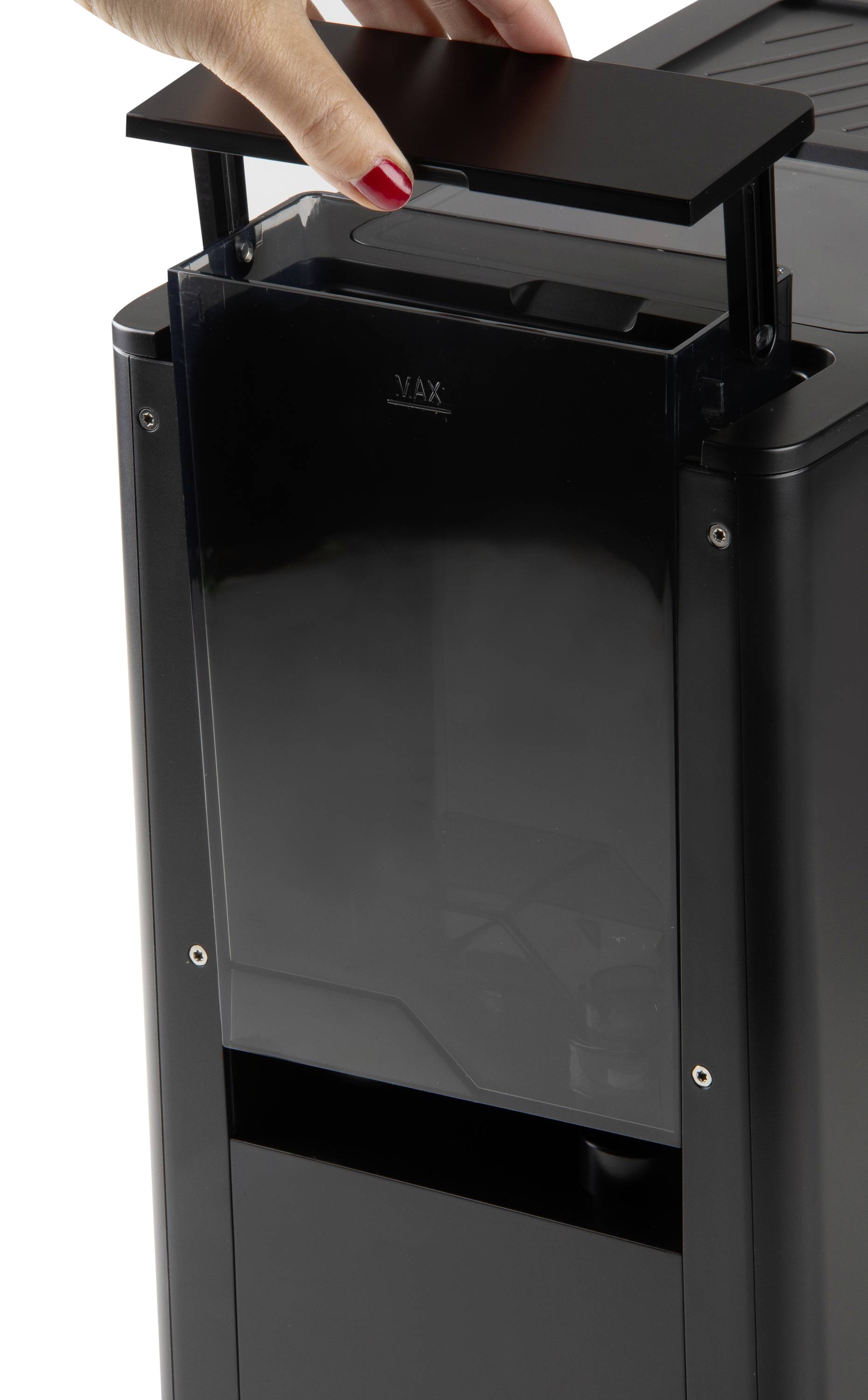 Close-up of a hand opening the top of a modern black device, possibly an air purifier or similar appliance.