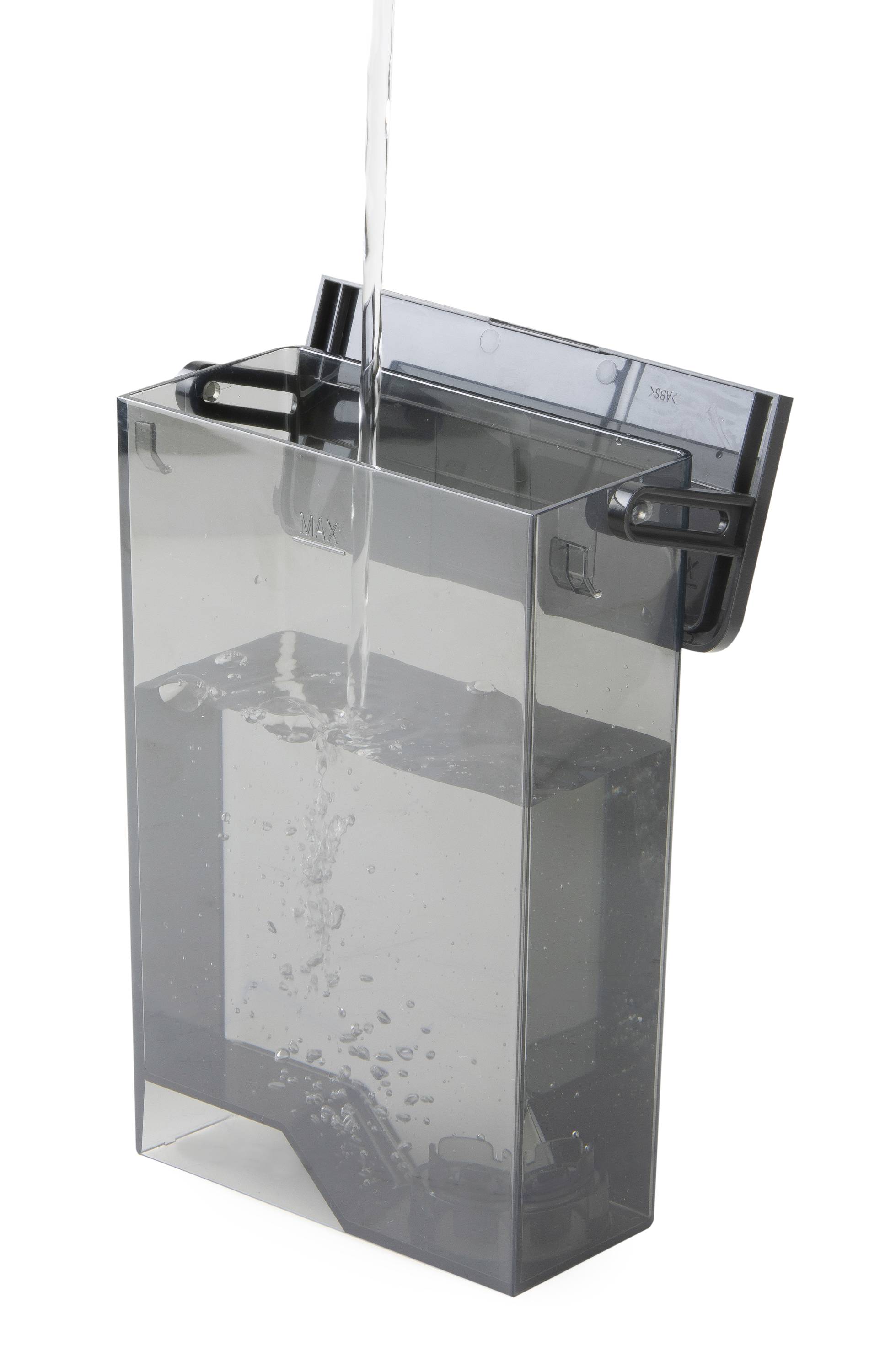 Water is poured into a transparent container with a lid that may belong to a household appliance.