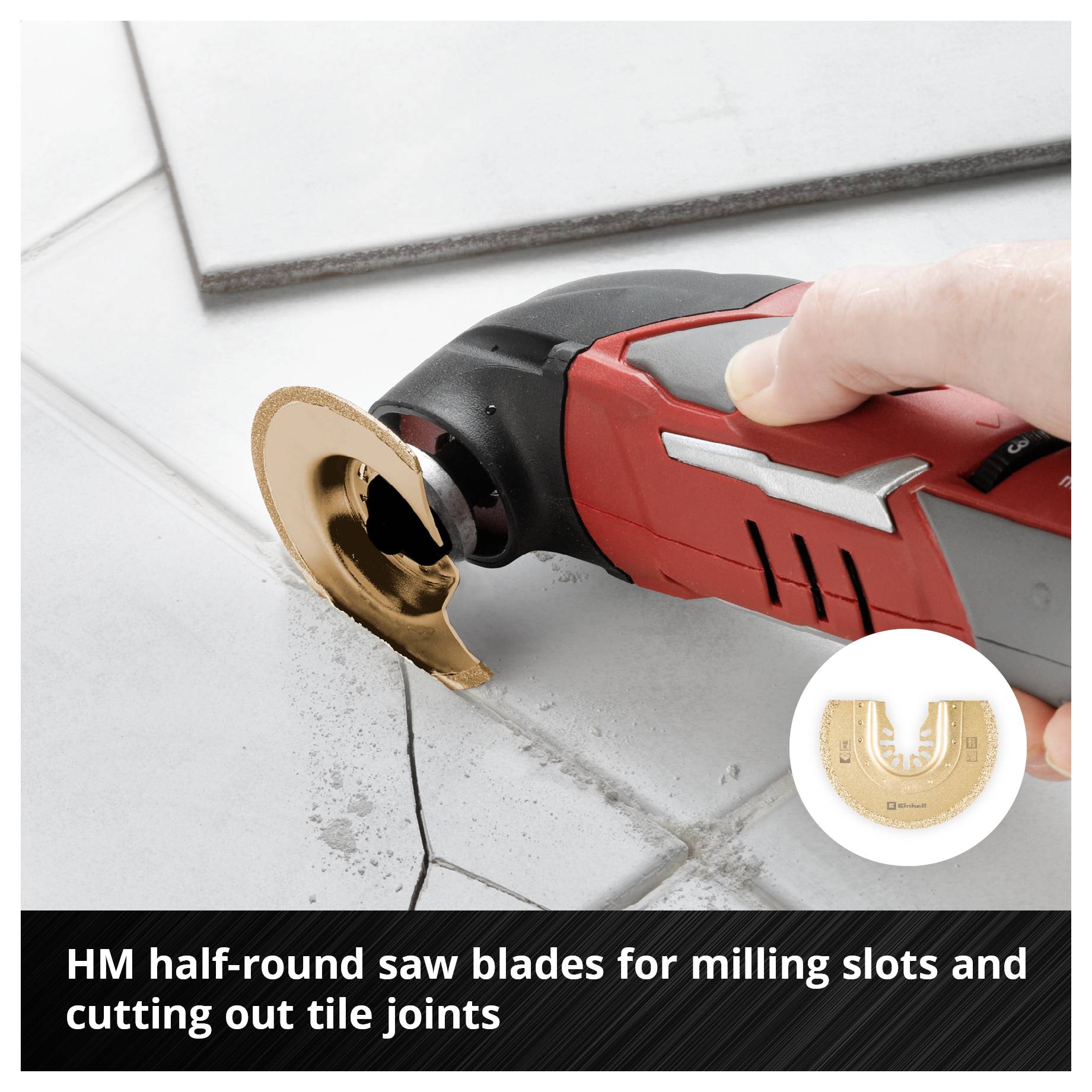 A hand holds an electrical multi-function tool with a crescent-shaped saw blade, precisely working on tile grout.
