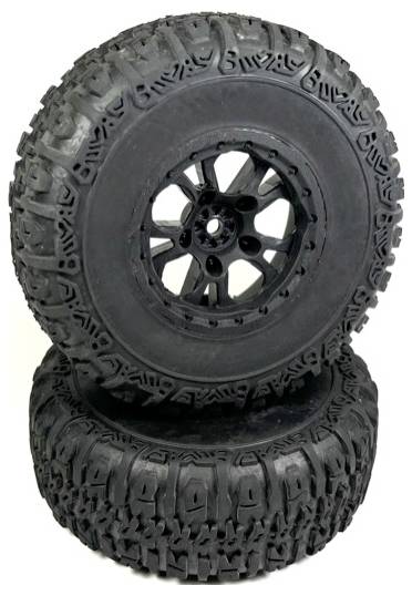 Two black, robust off-road tyres with deep tread, stacked on top of each other, suitable for off-road vehicles or model cars.