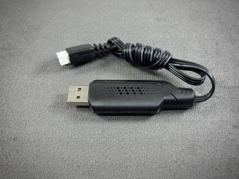 A black USB cable with a rectangular connector on one side and a round plug on the other, against a grey background.