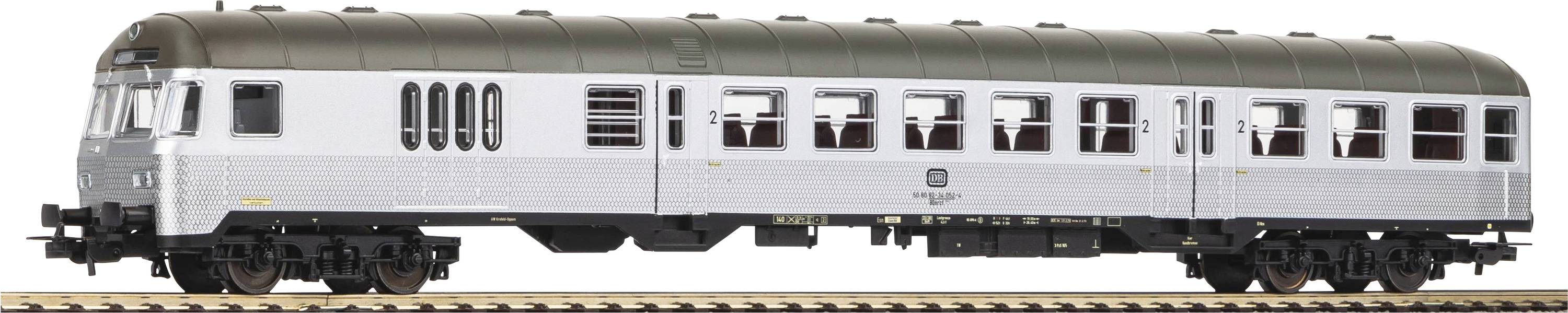 Silver passenger carriage of a train, standing sideways on tracks, with multiple windows and a dark roof.
