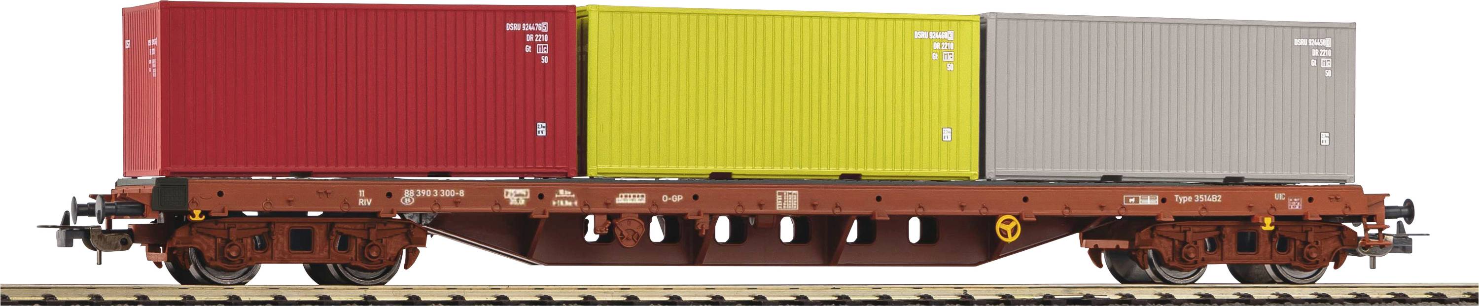 Freight train wagon with three colourful cargo containers, red, yellow and grey, on railway tracks.