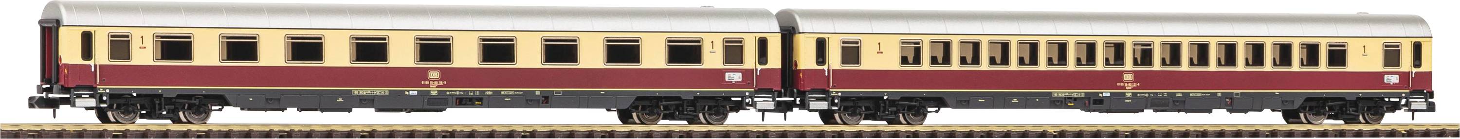 Two model railway passenger carriages in beige and red, positioned on a track.