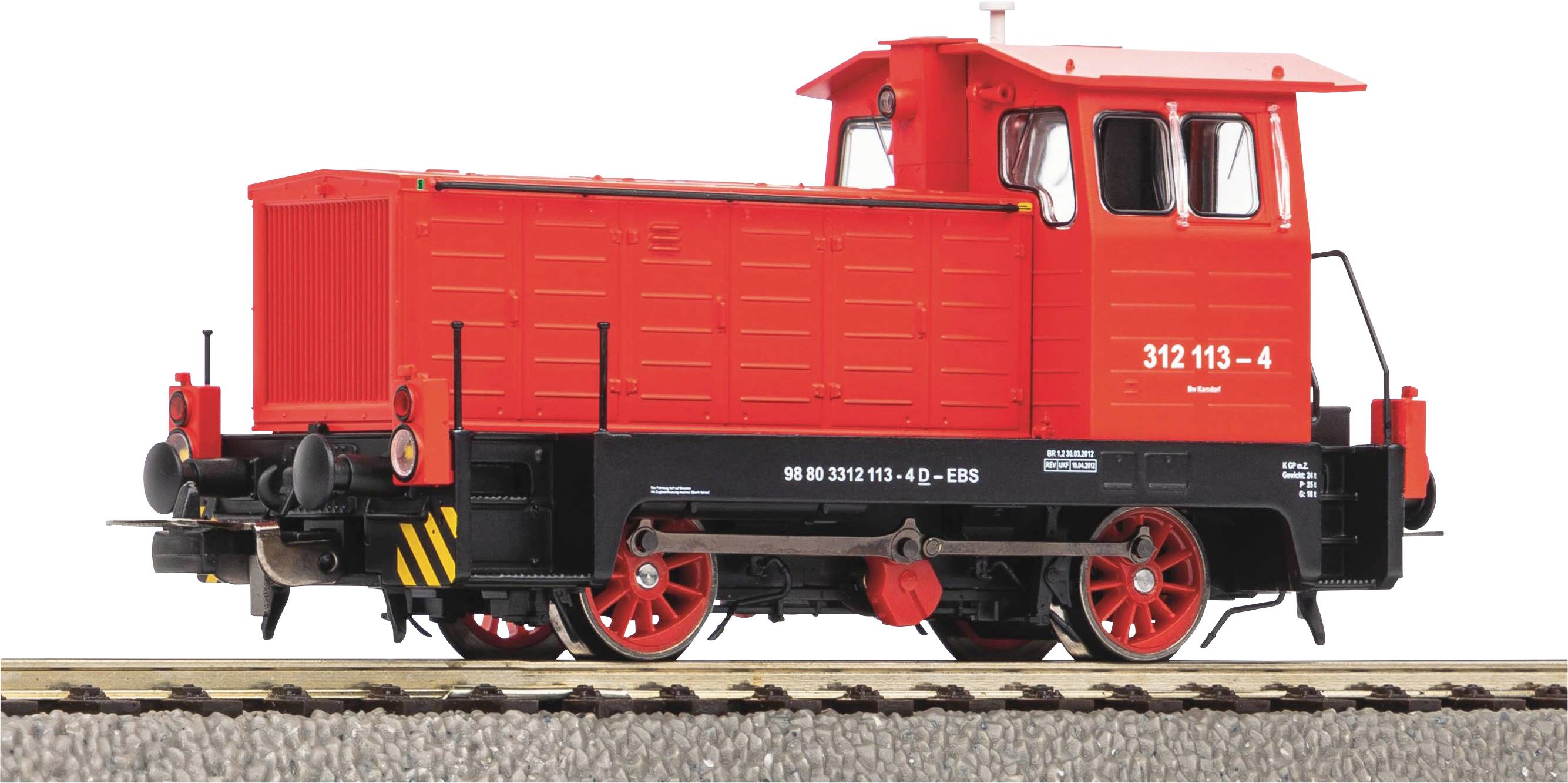 A red locomotive on railway tracks, side view. It bears the number '312 113-4'.