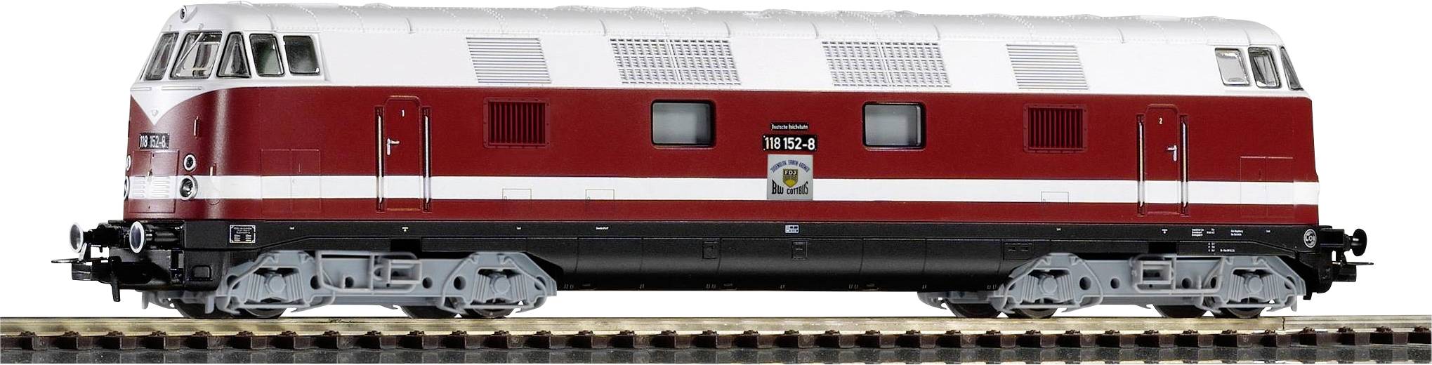 Red and white train on track, side view. Model of a historical locomotive, illuminated windows, black chassis.