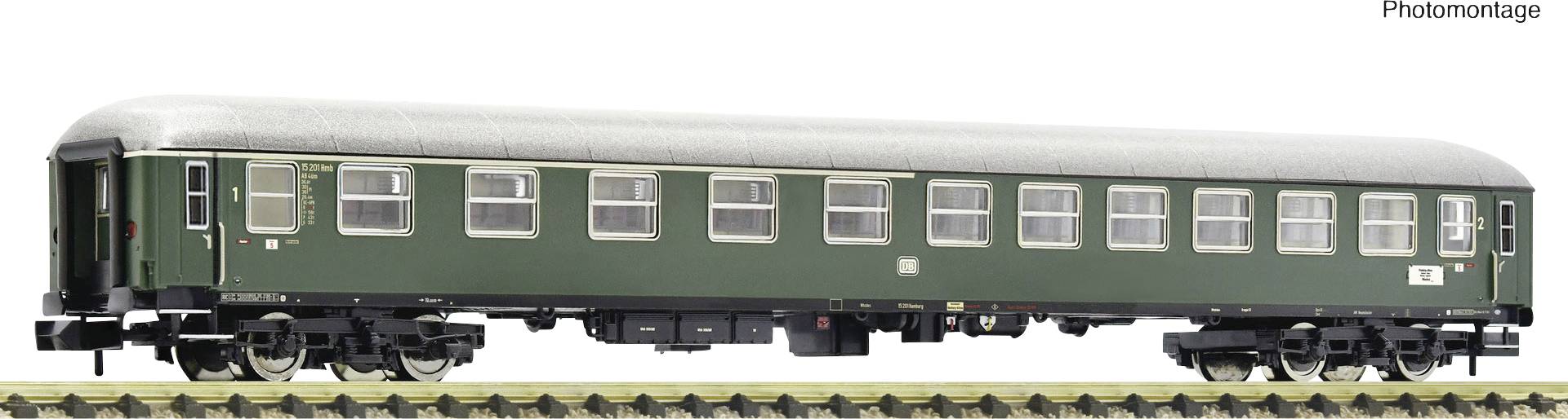 A green railway passenger carriage on a section of track. The carriage has multiple windows and a silver roof covering.