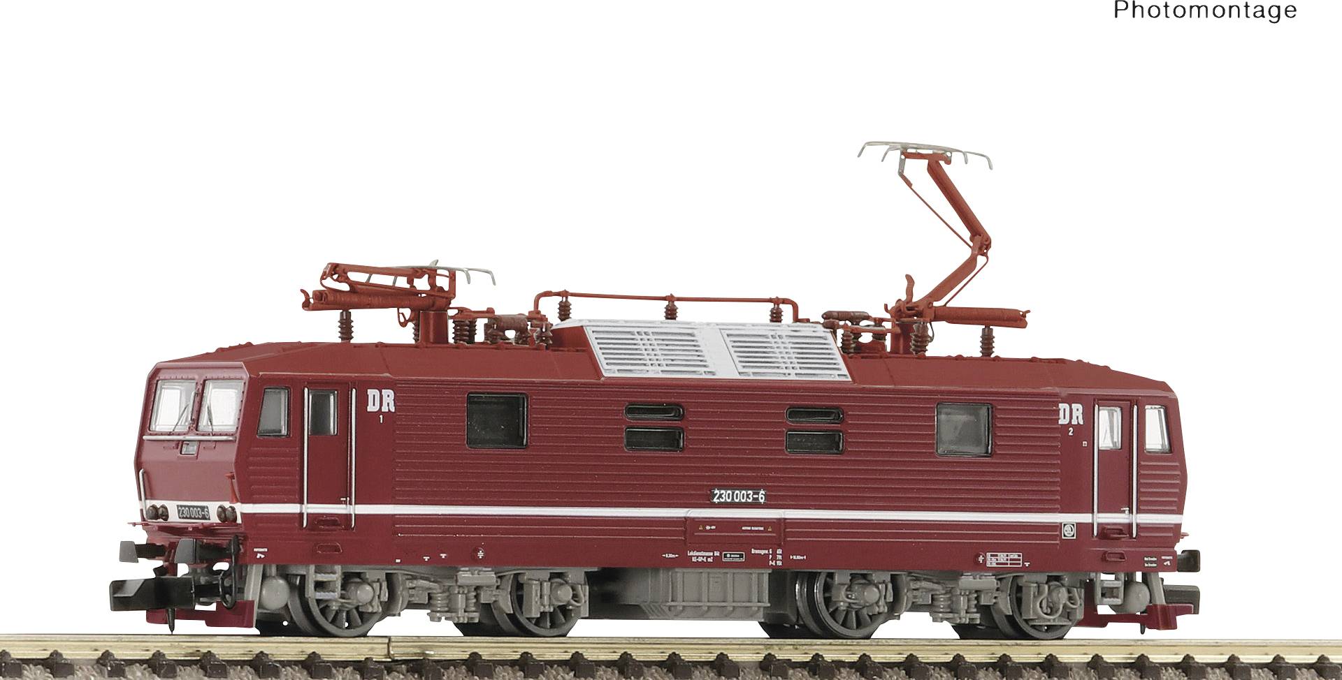 Model railway locomotive in red, positioned on a track. Locomotive parts are visibly detailed. 'DR' markings are identifiable.