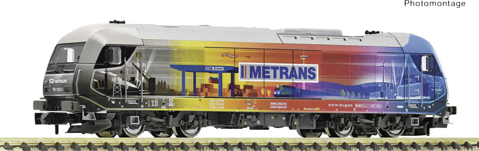 A colourful locomotive with the Metrans logo, standing on a railway track.
