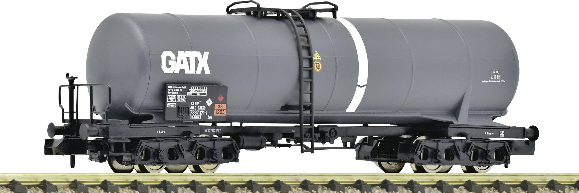 A black GATX tank wagon on a model railway track. The wagon has labels and safety symbols on its side.